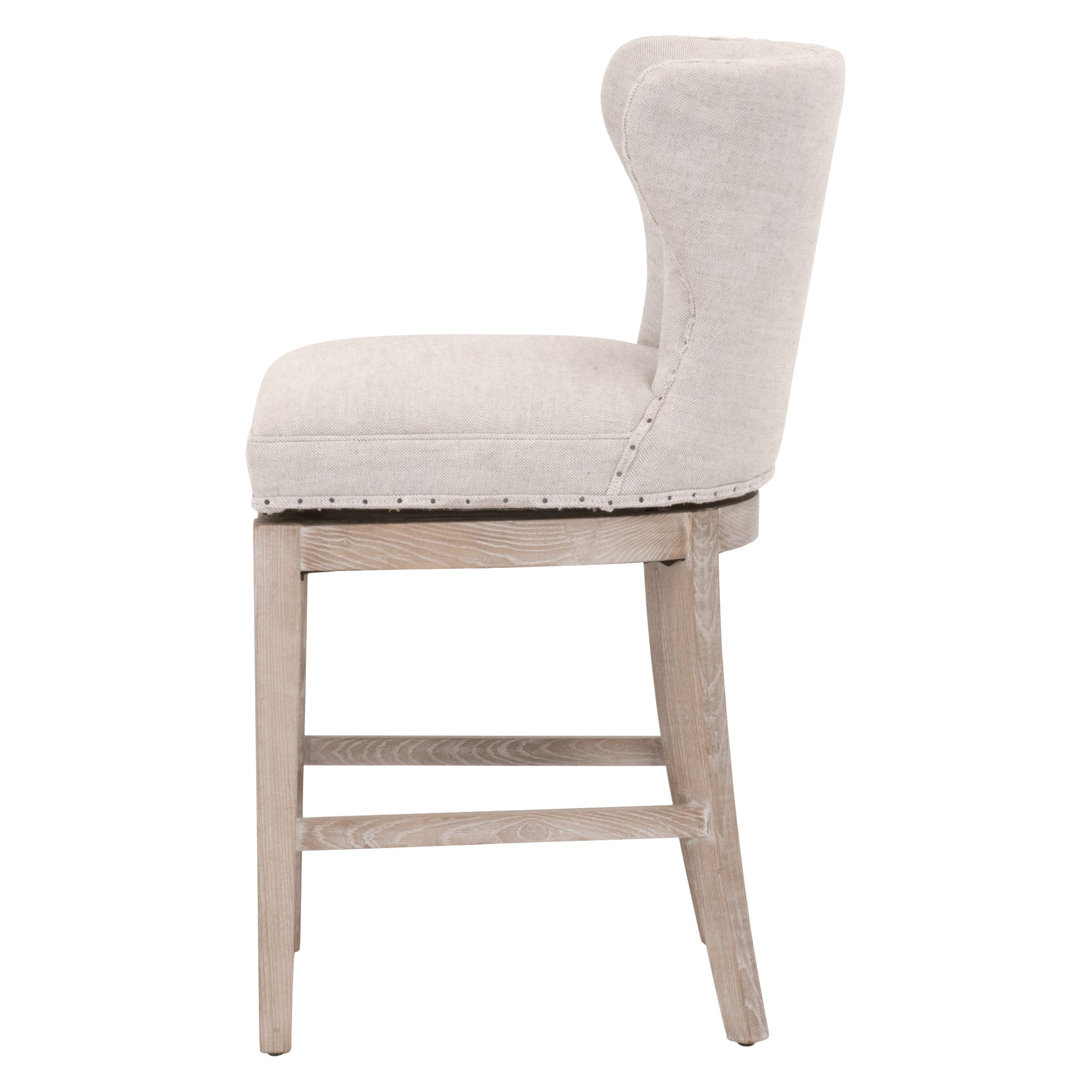 Side view of Essentials for Living Milton Swivel Counter Stool with Bisque French Linen upholstery and ash-wood frame