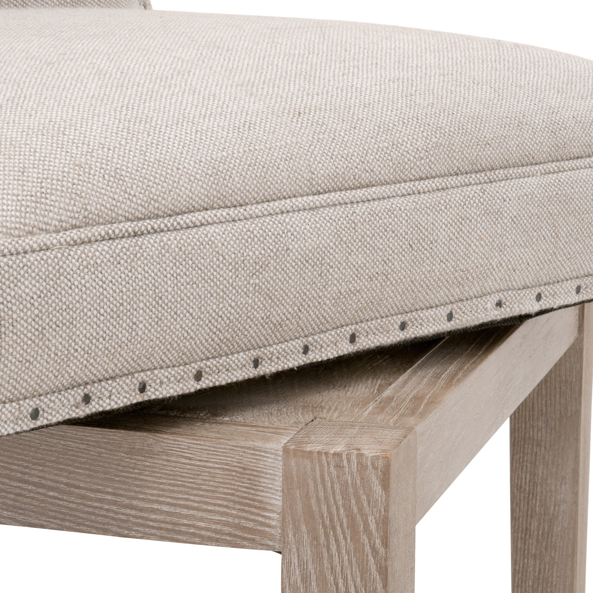 Close-up of Essentials For Living Milton Swivel Counter Stool with bisque French linen upholstery and ash wood frame