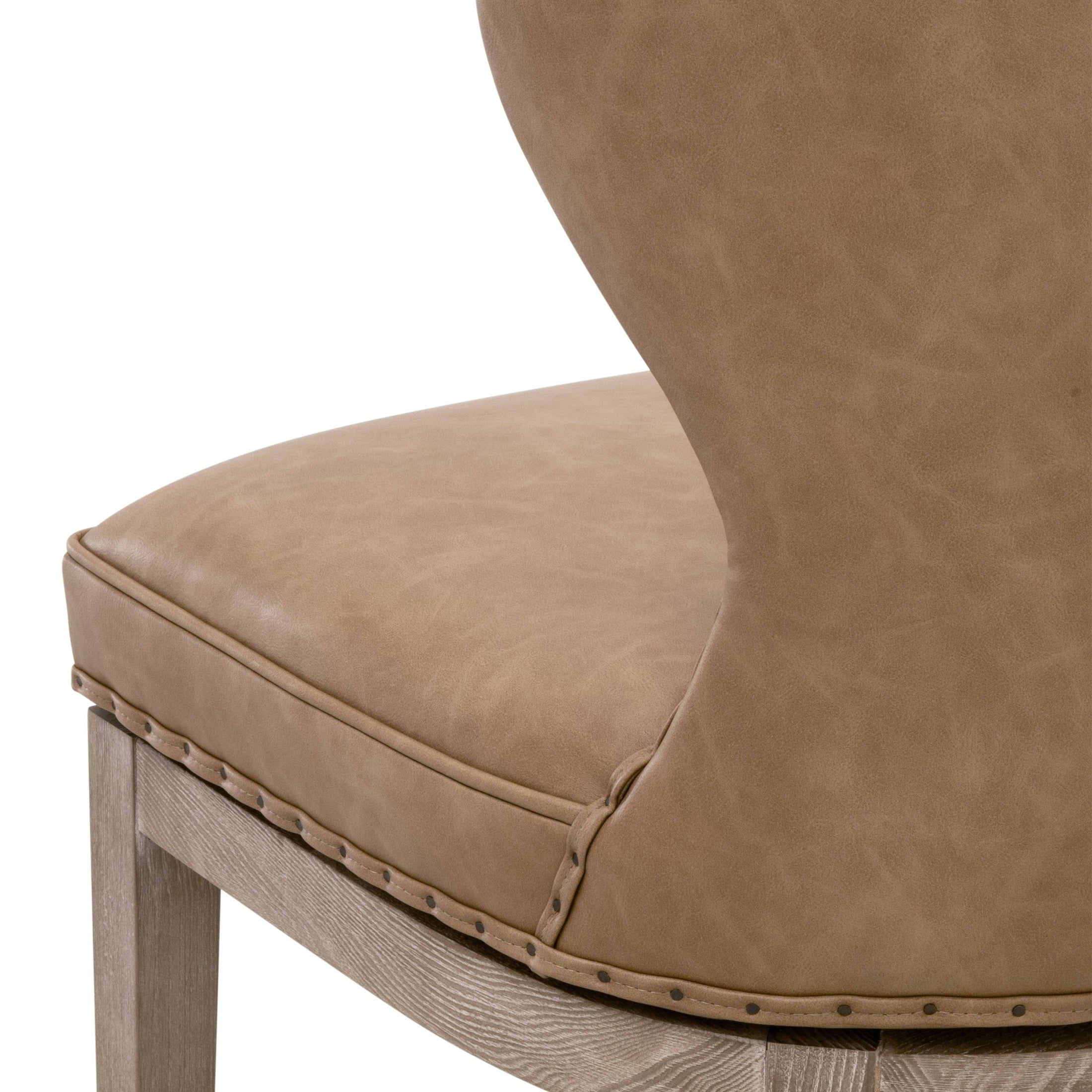 Close-up of Milton swivel counter stool seat with bisque French linen upholstery and nail-tack trim by Essentials for Living