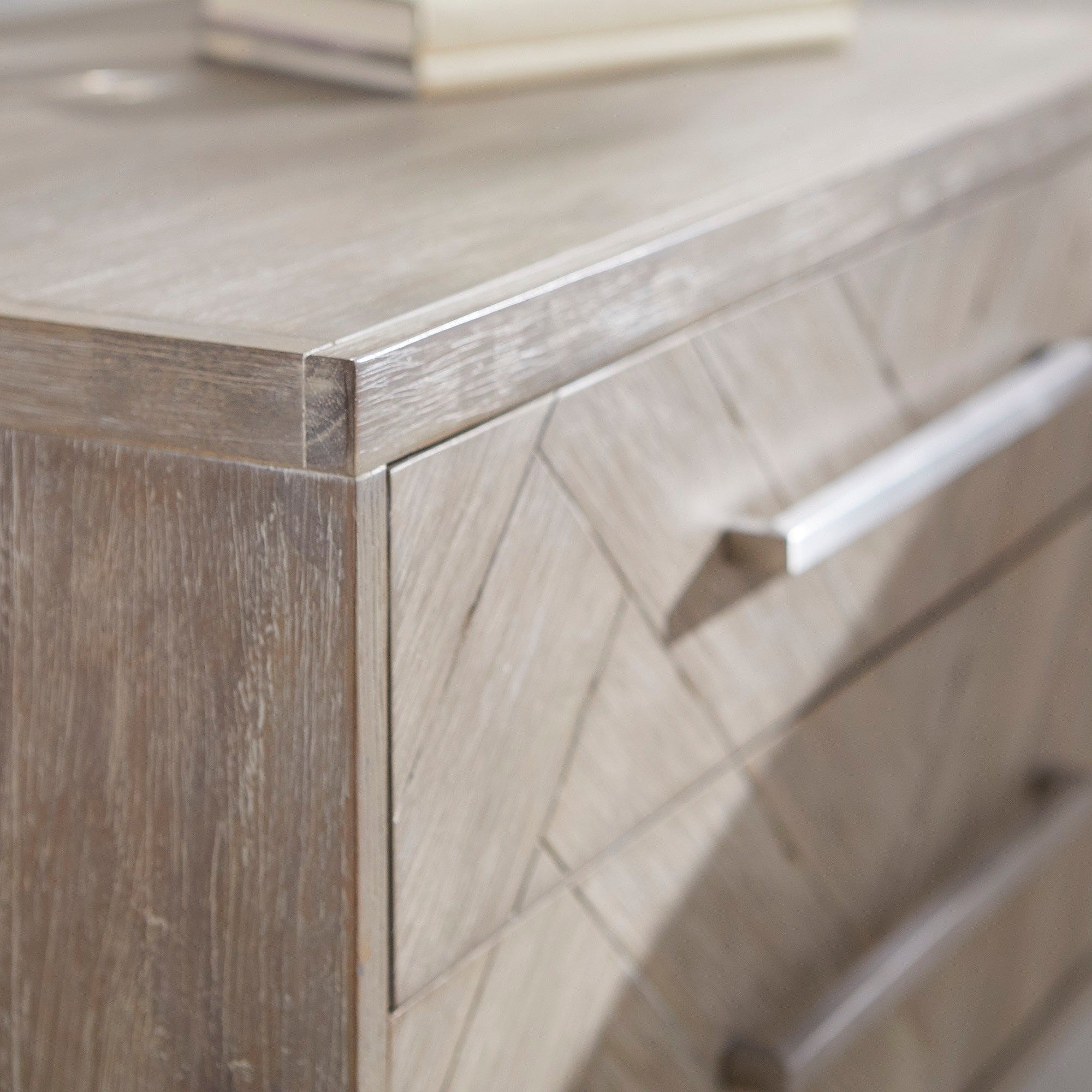Close-up of Mosaic 2-Drawer Nightstand with natural gray acacia veneer and stainless steel handle by Essentials for Living