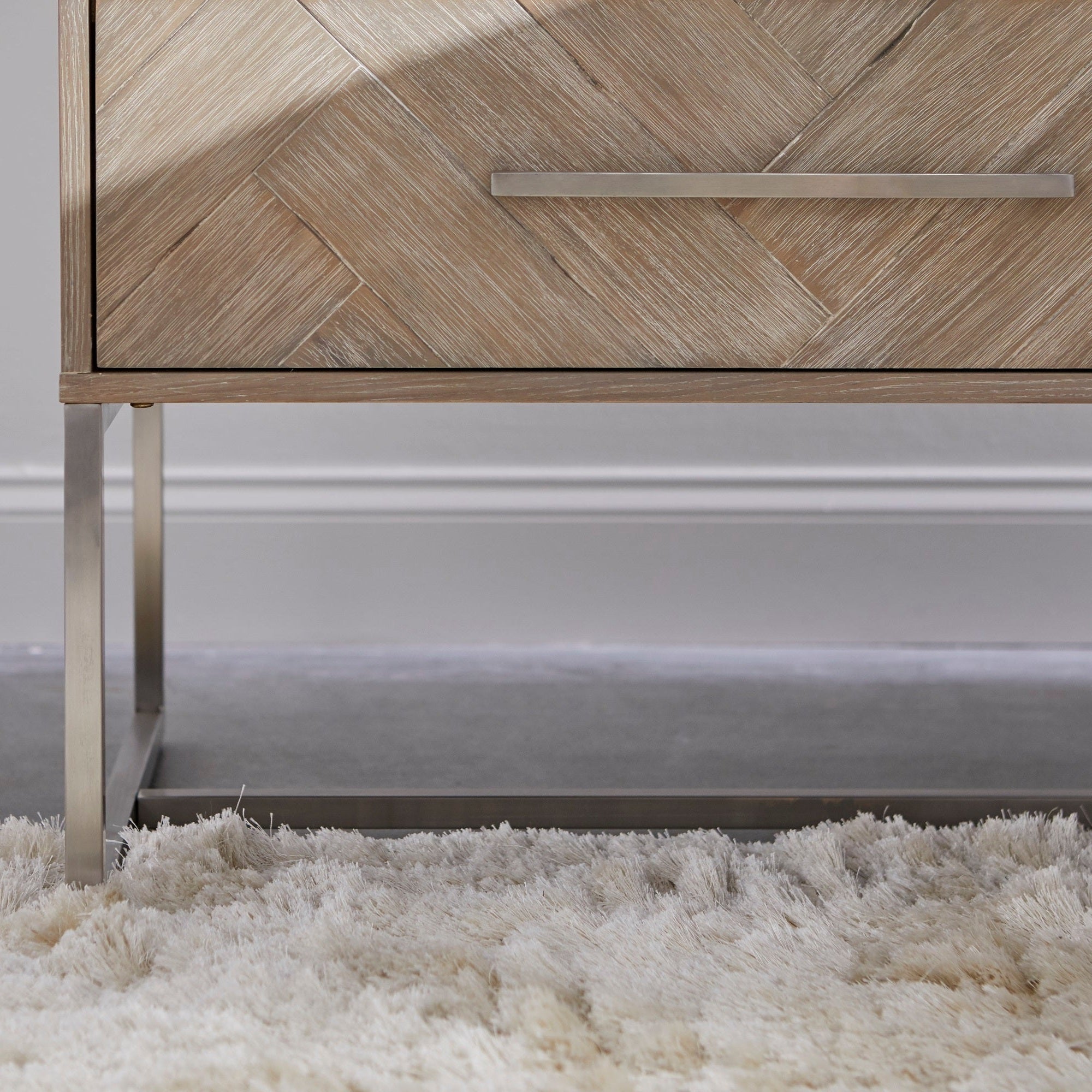 Close-up of Mosaic 2-Drawer Nightstand with natural gray acacia veneer and brushed stainless steel base by Essentials for Living