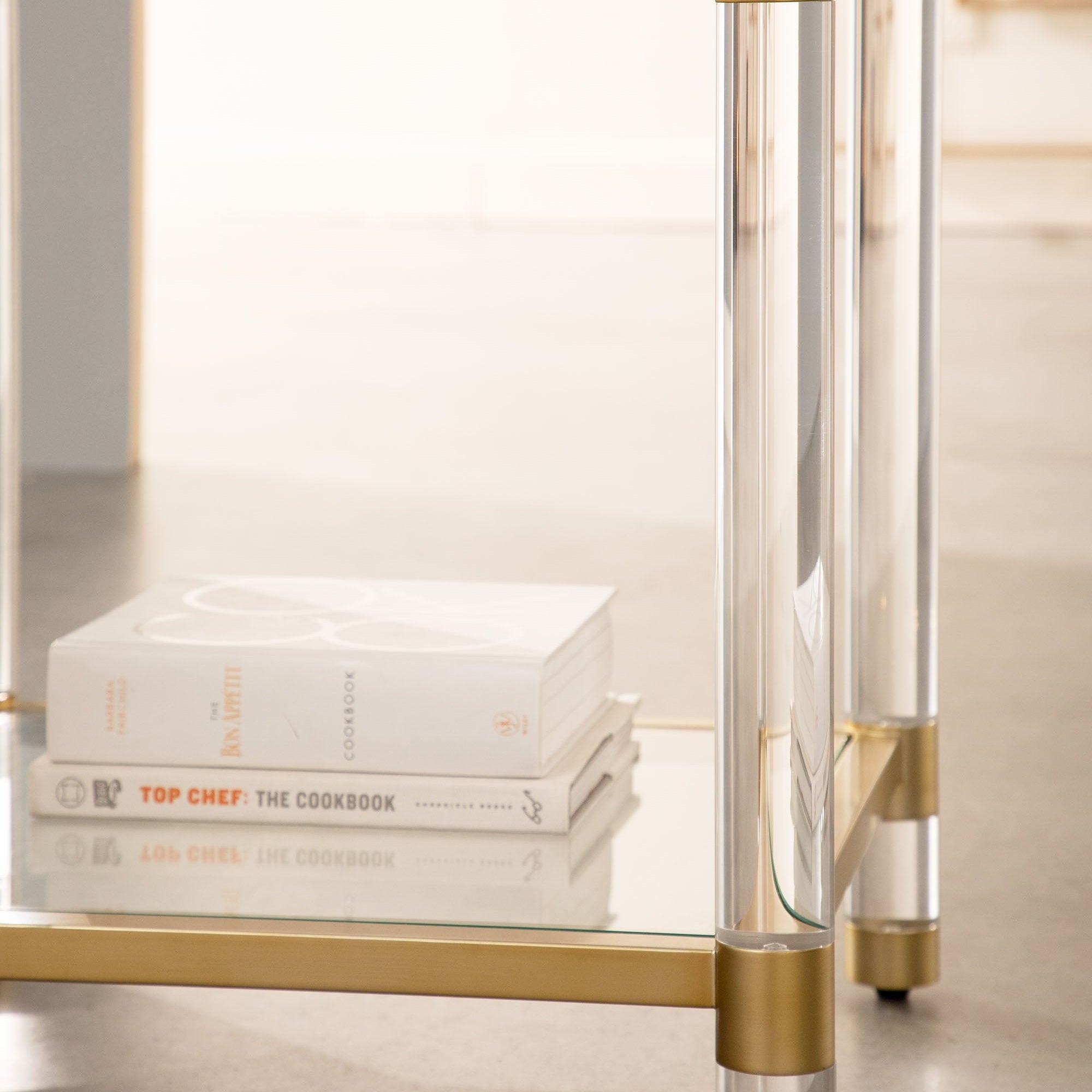 Clear glass shelf and Lucite acrylic legs detail on Nouveau End Table by Essentials for Living.