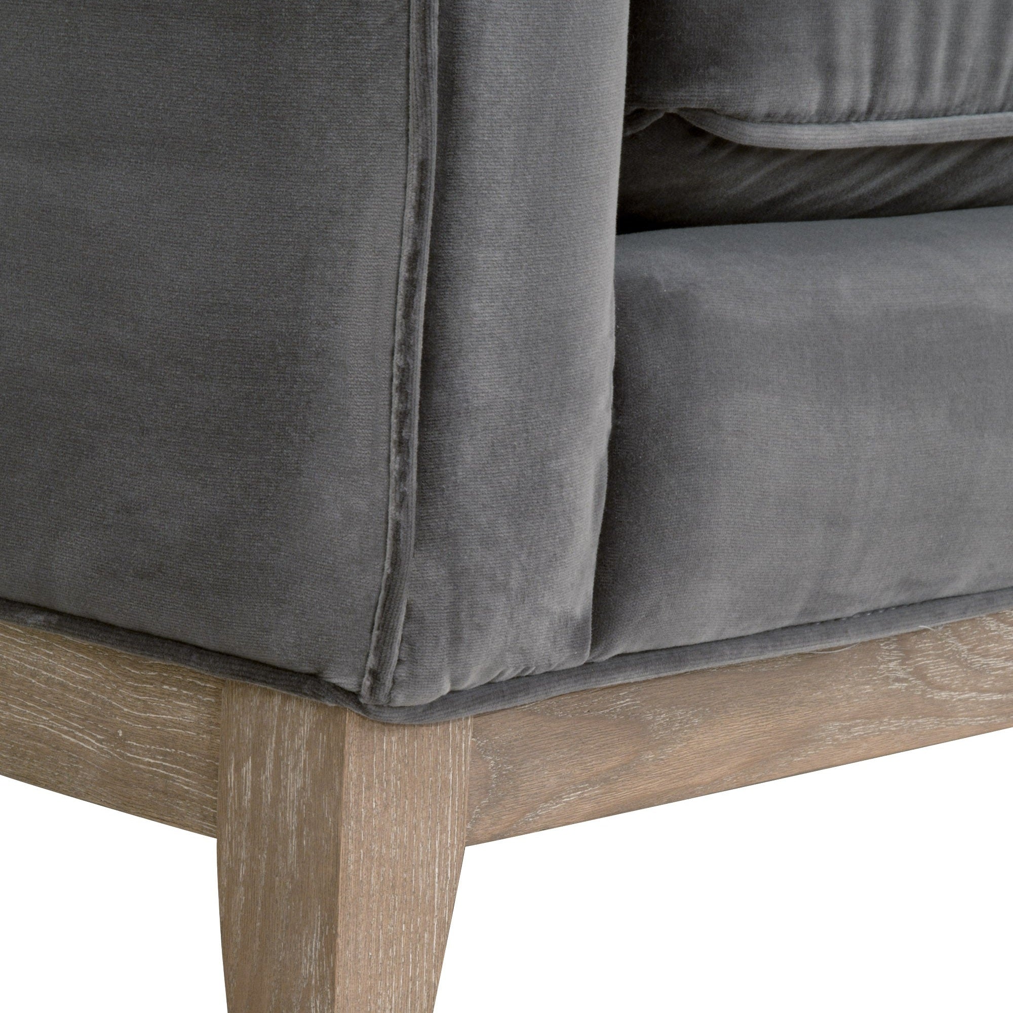 Close-up of Parker 86 sofa corner with gray velvet upholstery and natural gray oak wooden leg by Essentials For Living