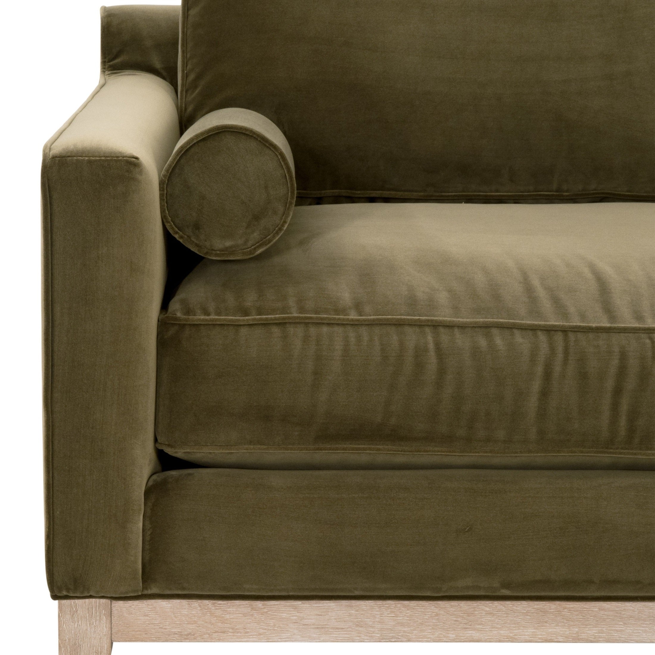 Close-up of olive green velvet Parker 86 sofa by Essentials For Living with natural gray oak base and bolster pillow