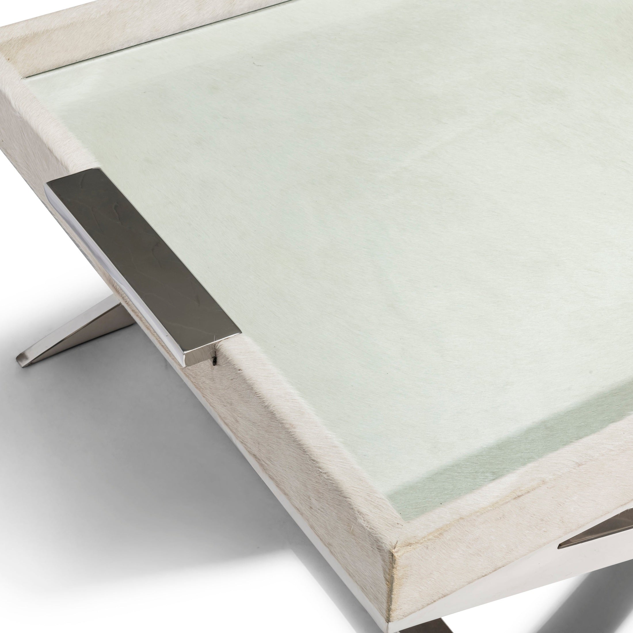Close-up of Parse Coffee Table with natural hide, glass top, and chrome handle by GO HOME