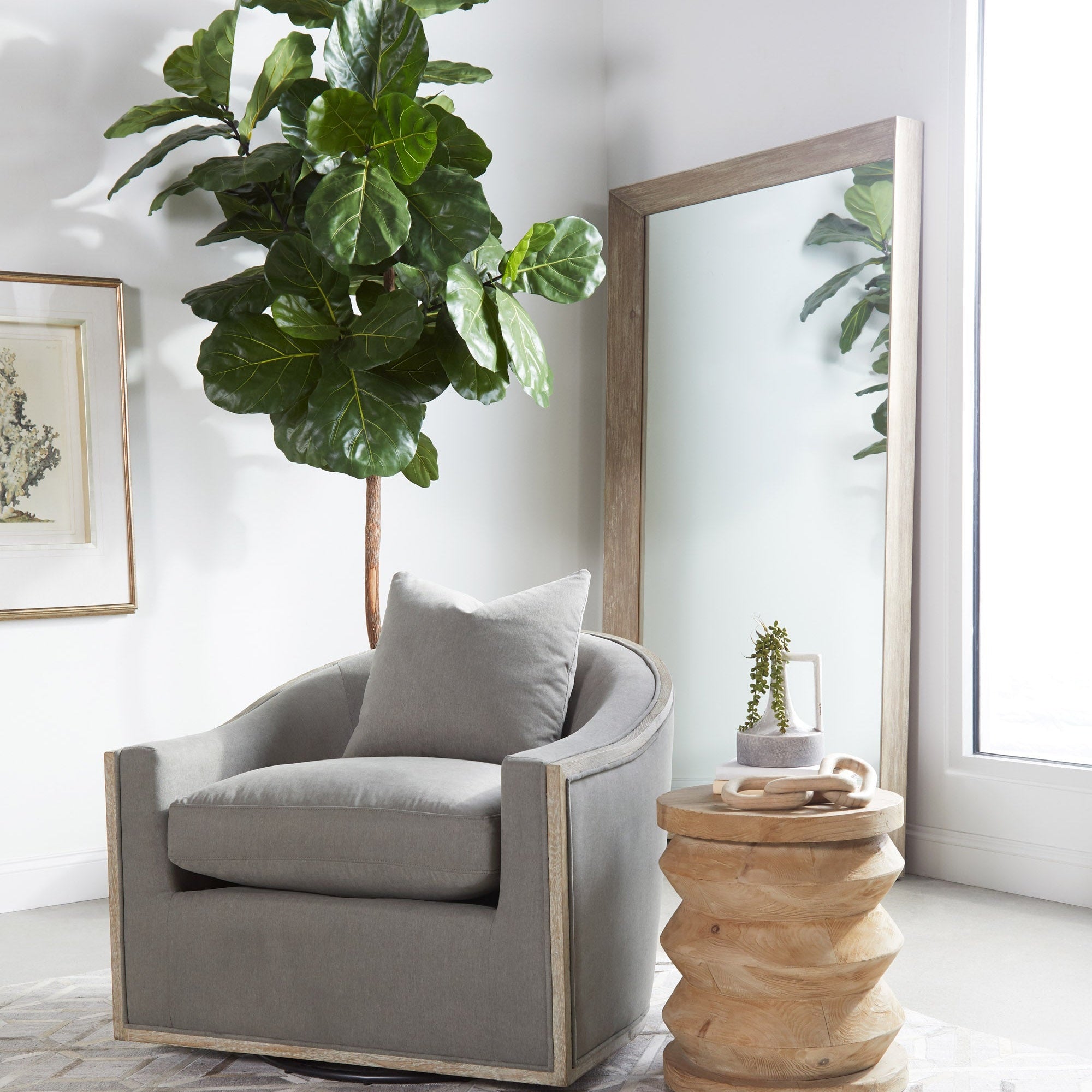 Essentials For Living Paxton Swivel Club Chair in gray fabric with solid oak trim in a bright, modern room setting