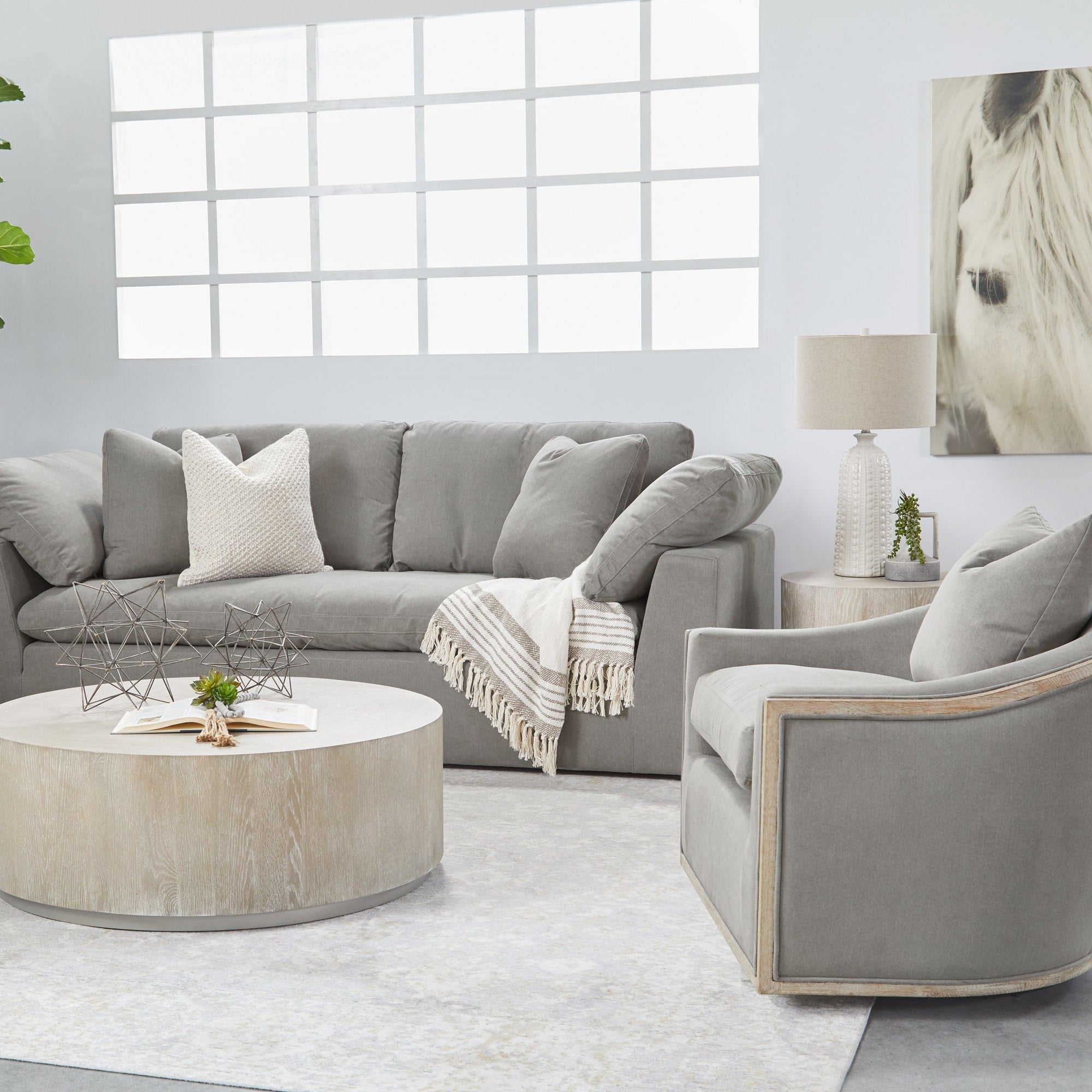 Gray Paxton Swivel Club Chair with natural oak trim in modern living room by Essentials for Living
