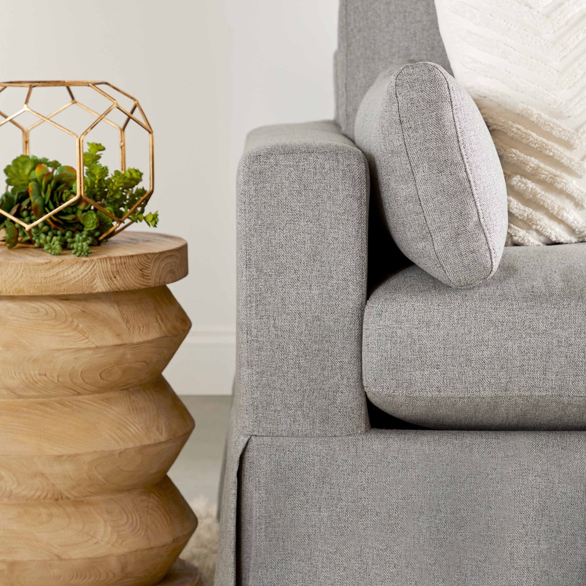 Cylindrical Pier Accent Table in reclaimed pine with smoke gray finish next to a modern grey upholstered sofa.