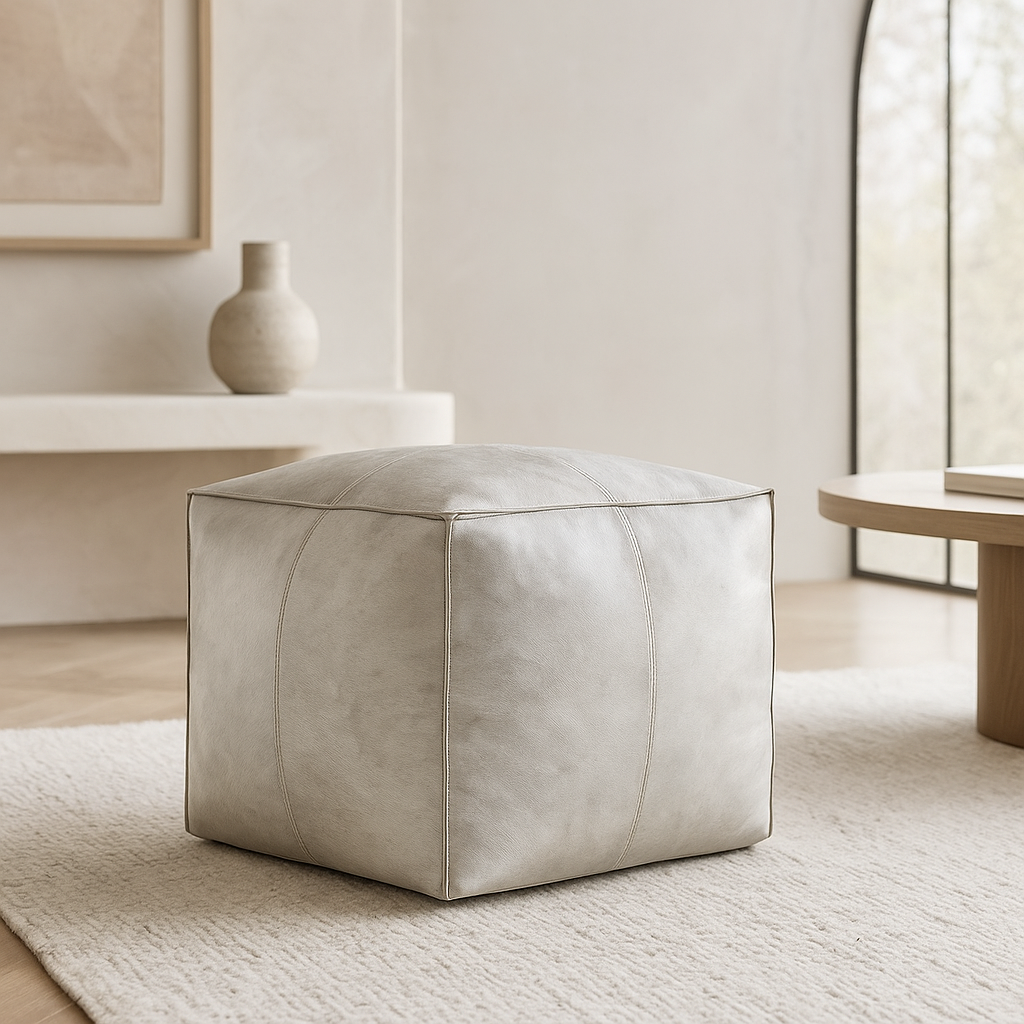 Rio Hide Pouf 18" in grey hair-on-hide with cube silhouette placed on rug in modern room GO HOME