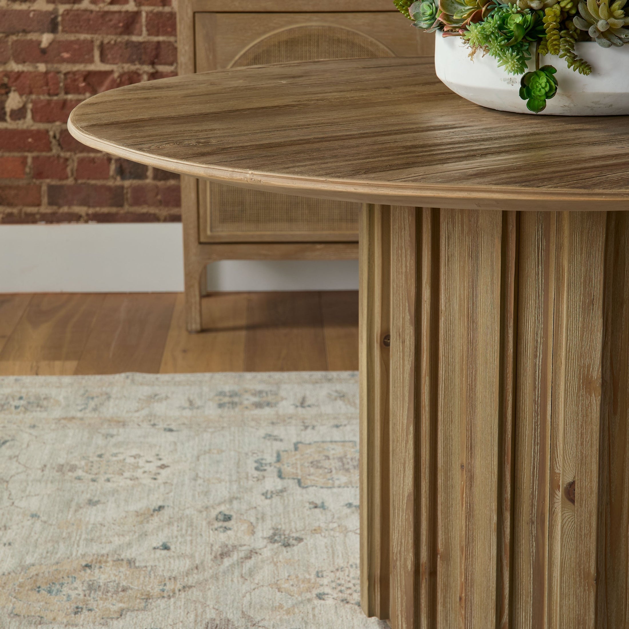 Close-up of Roma 54" Round Dining Table with fluted pedestal base in reclaimed pine by Essentials For Living.