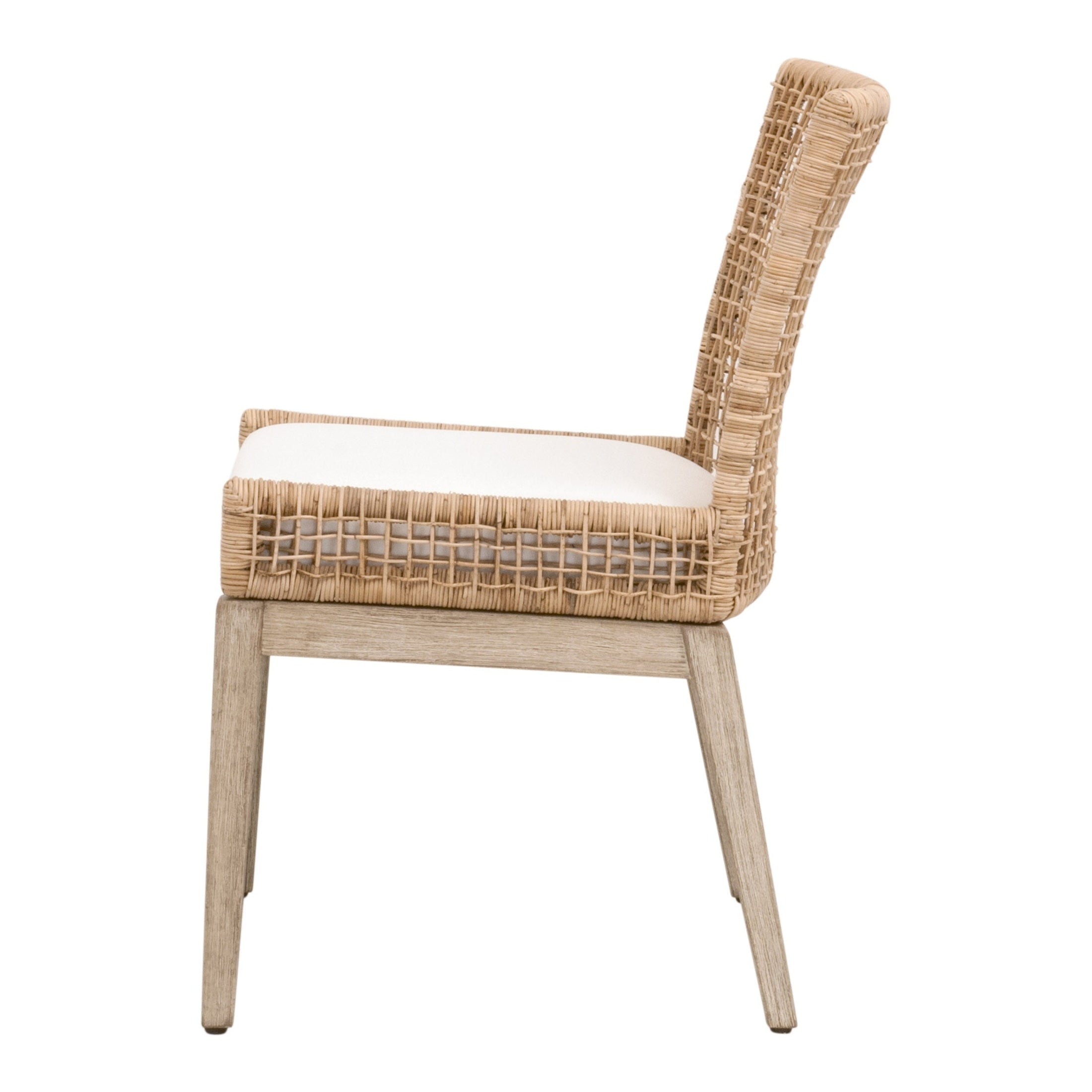 Side view of Essentials For Living Seaside Dining Chair with natural rattan back and cushioned seat