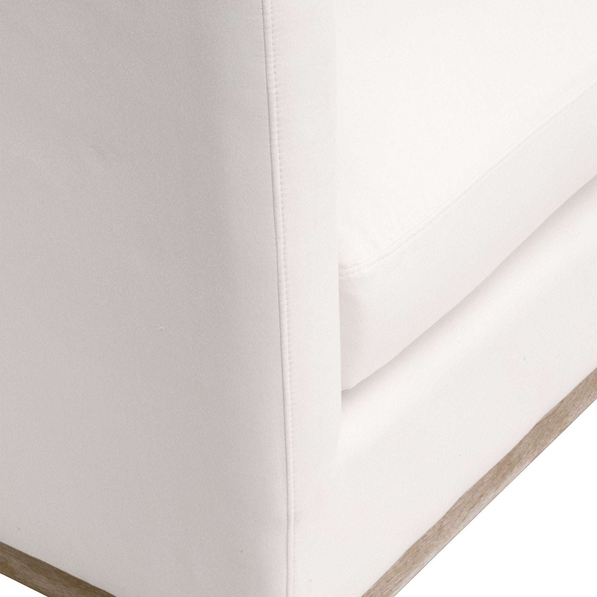 Close-up of ivory upholstered corner with exposed wood plinth base on the Siena 96" sofa by Essentials For Living.
