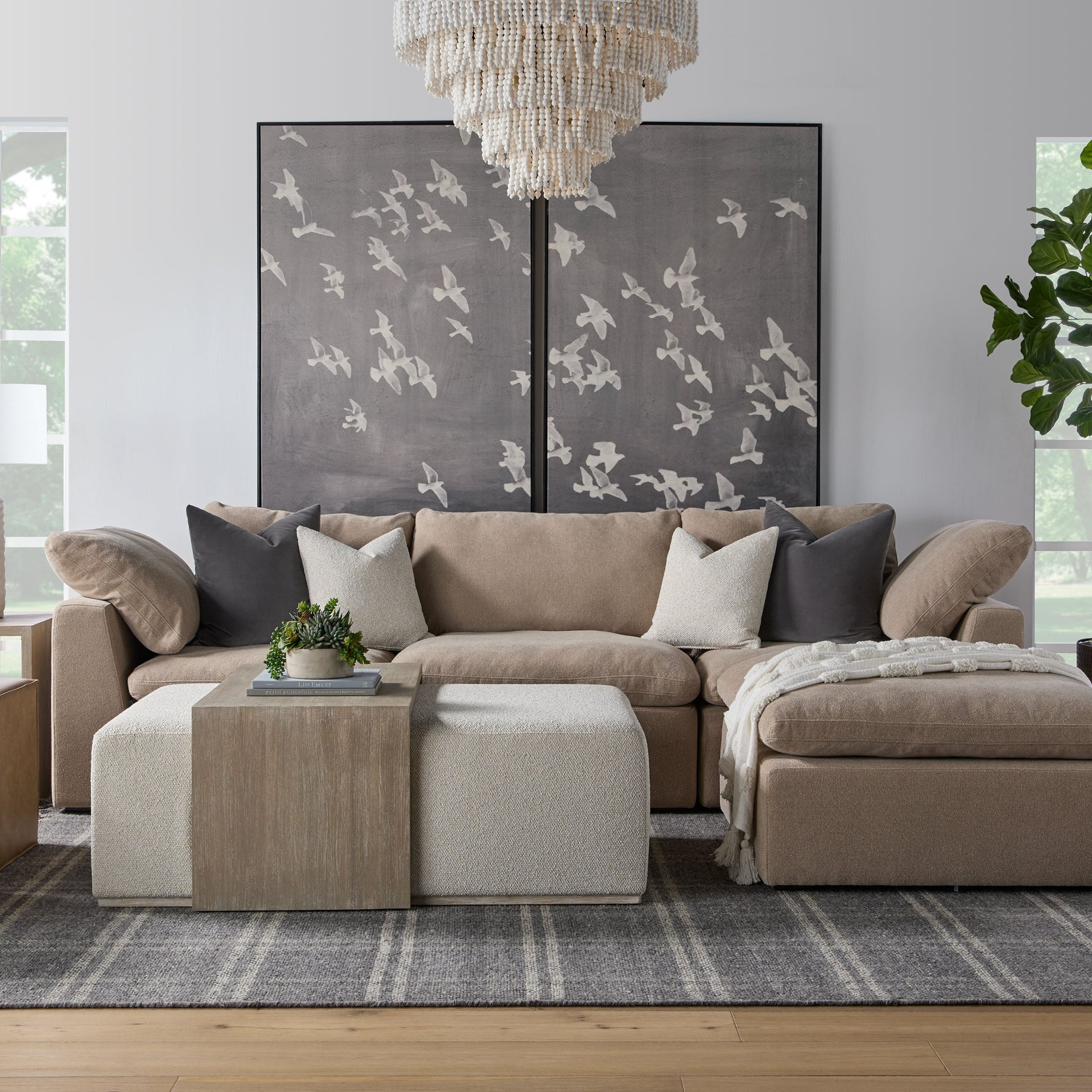 Transitional living room featuring Essentials For Living Sky Modular sofa set with neutral tones and modern art accents