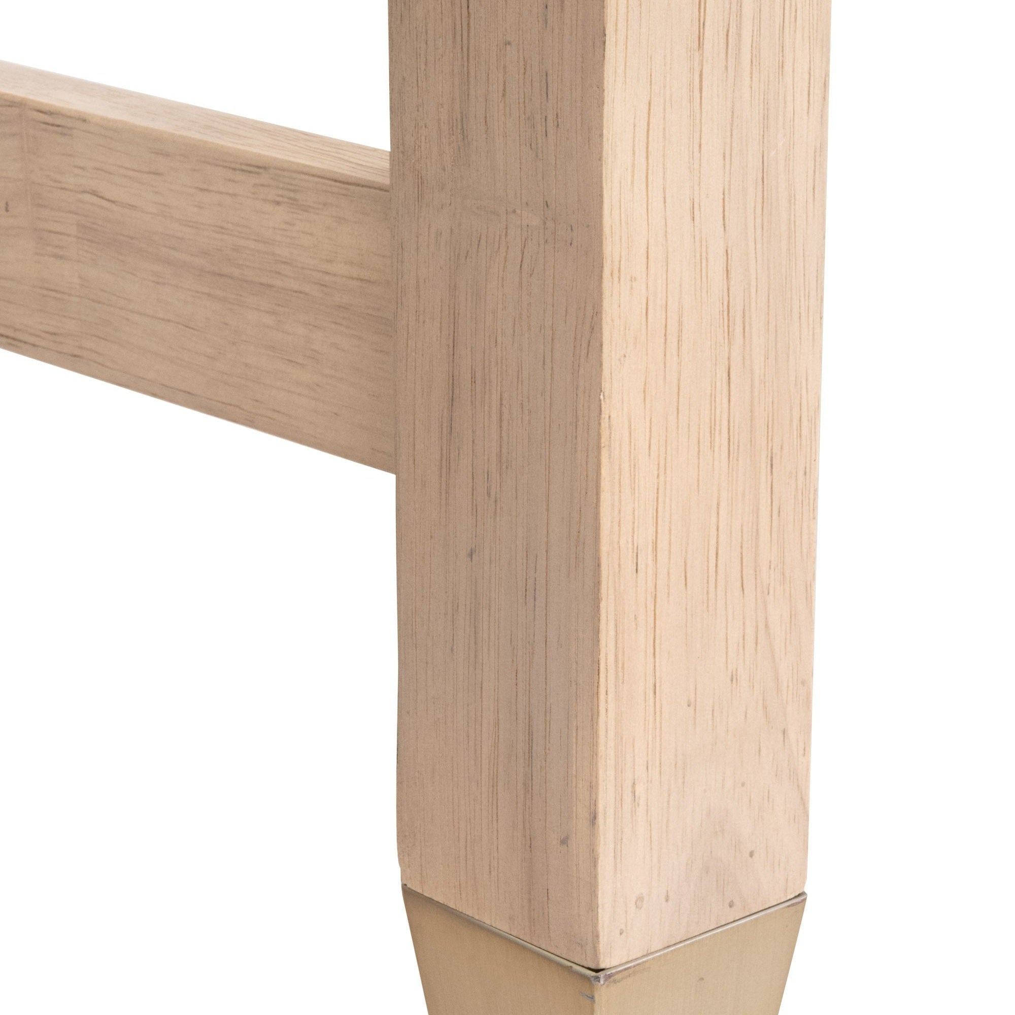 Close-up of solid rubberwood leg with natural grain and brushed brass foot detail on Stella Desk by Essentials for Living