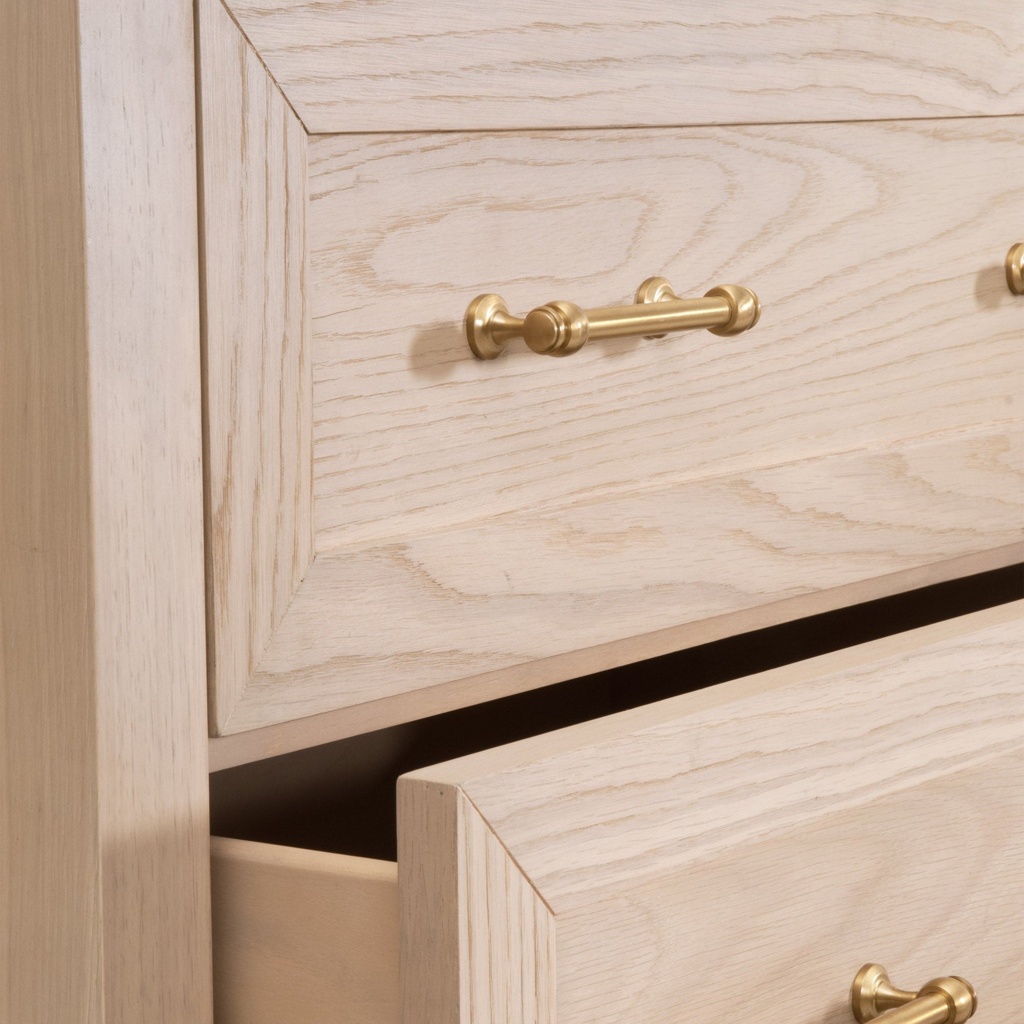 Close-up of the Stella 6-Drawer Double Dresser showing matte white wood finish and brushed brass drawer handle detail