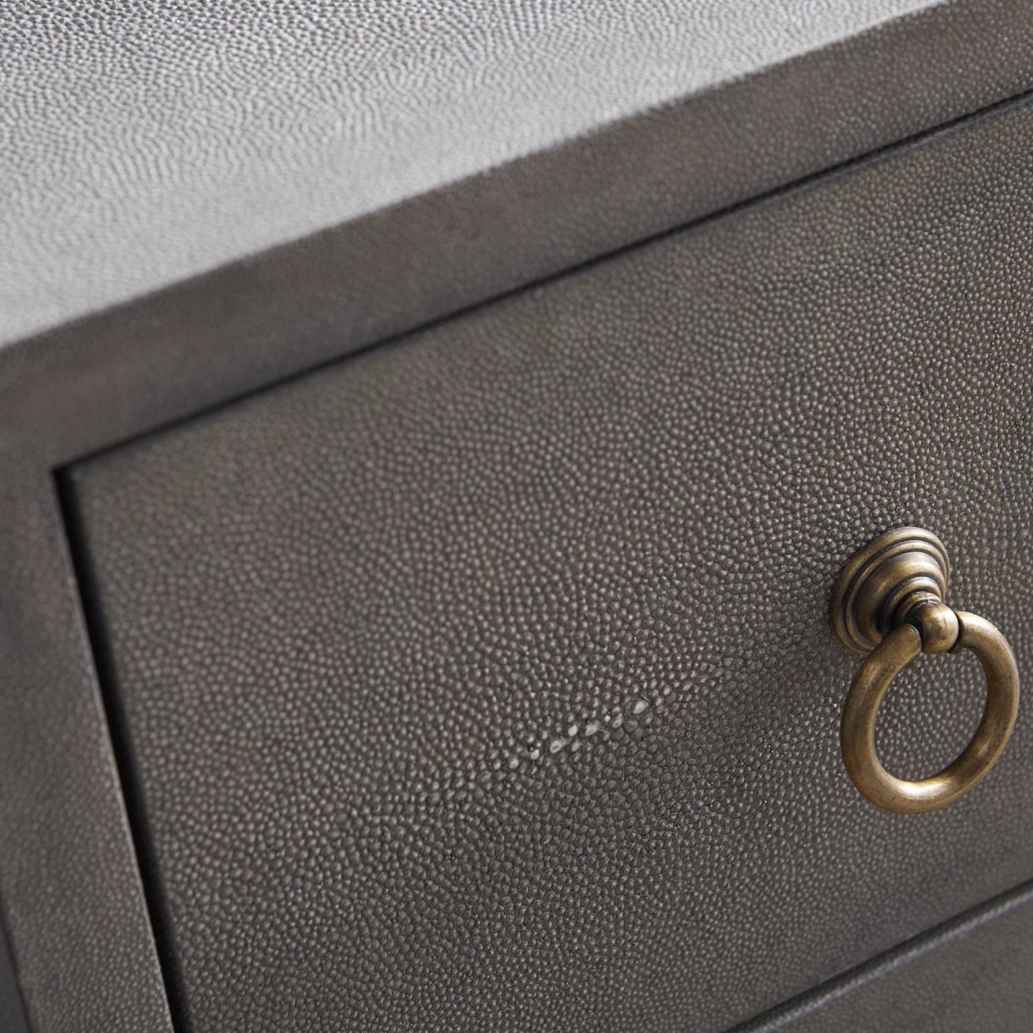 Close-up of pearl white faux shagreen drawer with brushed gold ring pull on Essentials for Living dresser
