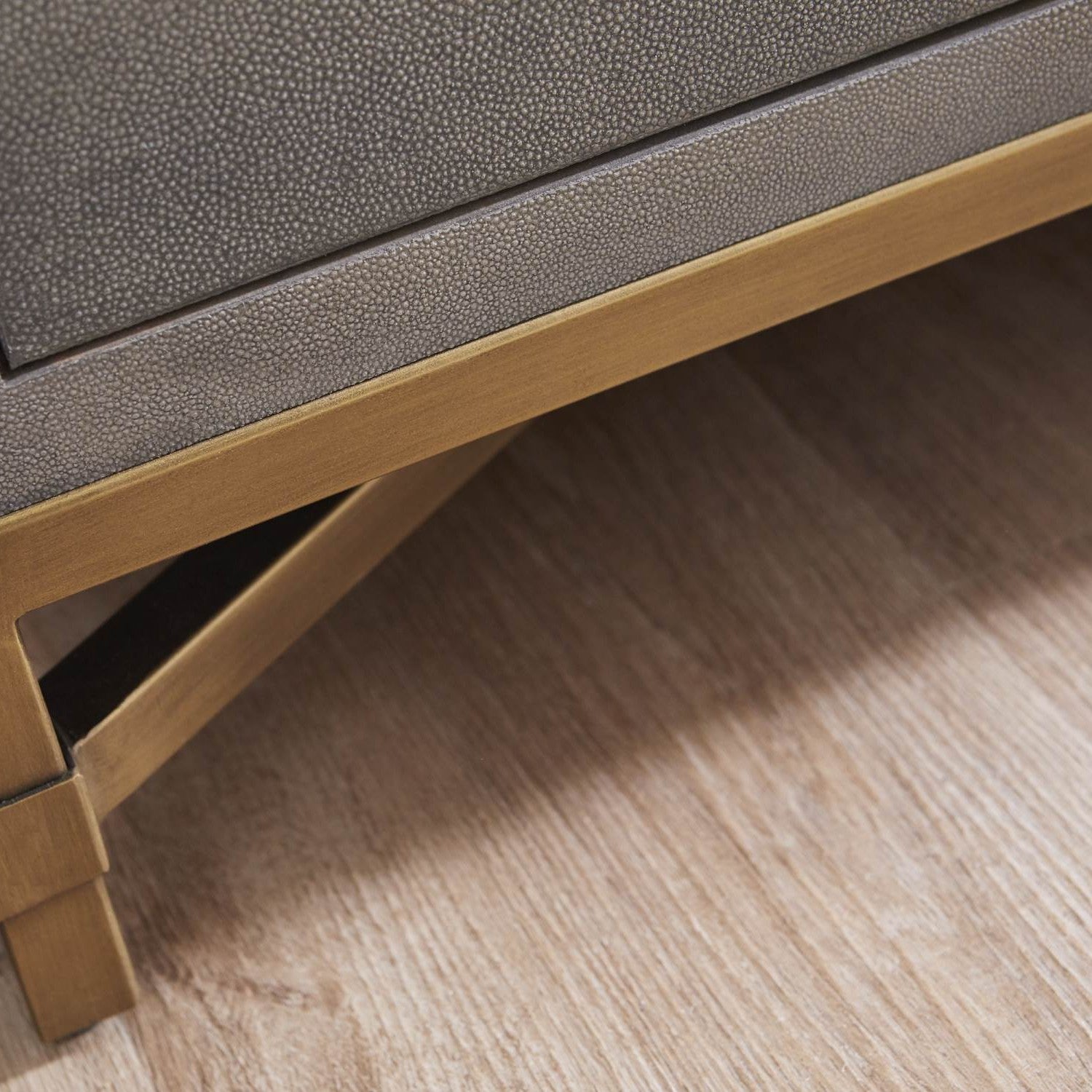 Close-up of pearl white faux shagreen texture and brushed gold steel base on Essentials for Living Strand Shagreen dresser.