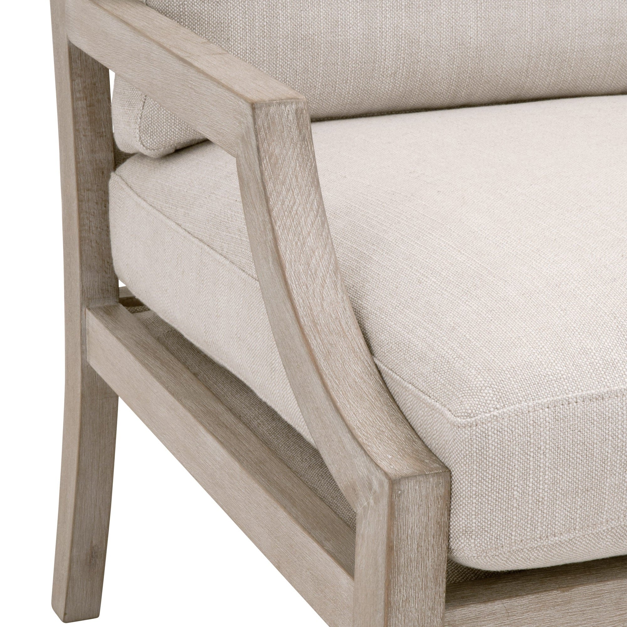 Close-up of Stratton Club Chair’s soft white boucle upholstery and natural gray beech wood frame armrest detail.