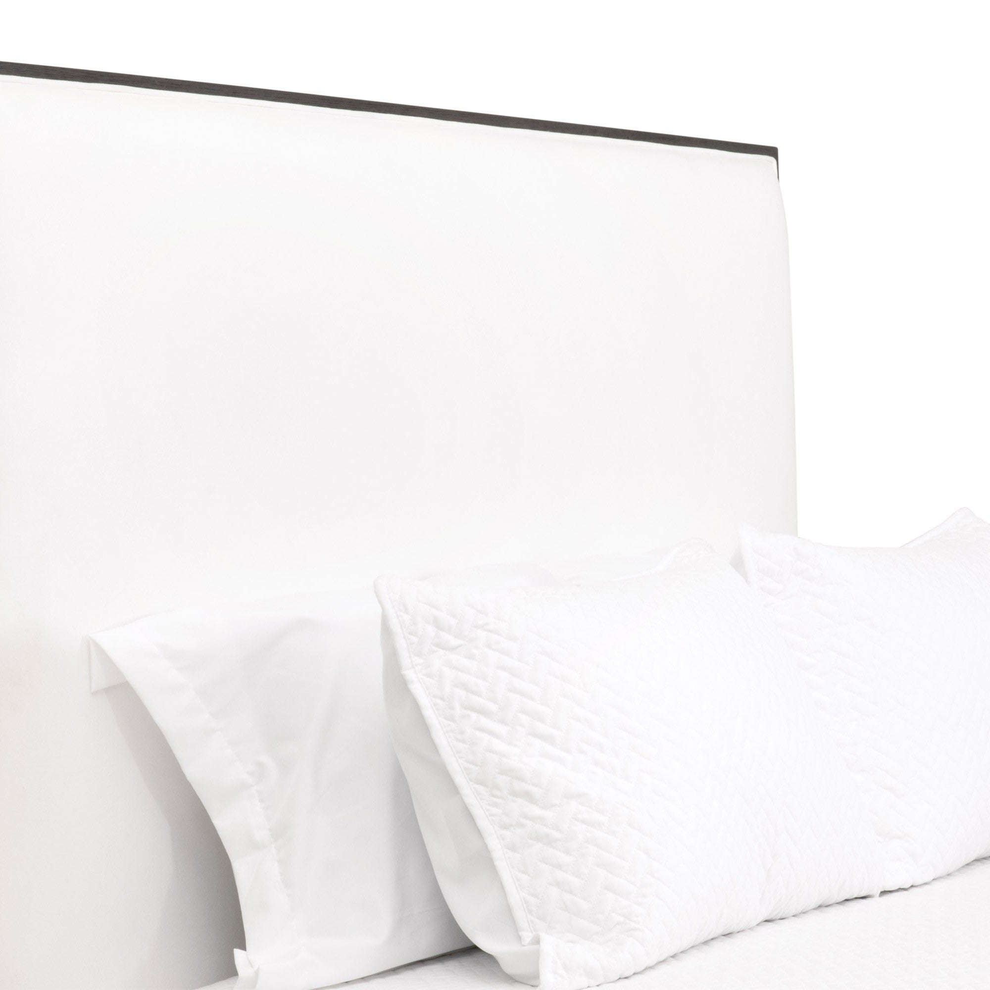 Close-up of Tailor Standard King Bed headboard upholstered in white LiveSmart Peyton-Pearl fabric with matte brown oak trim.