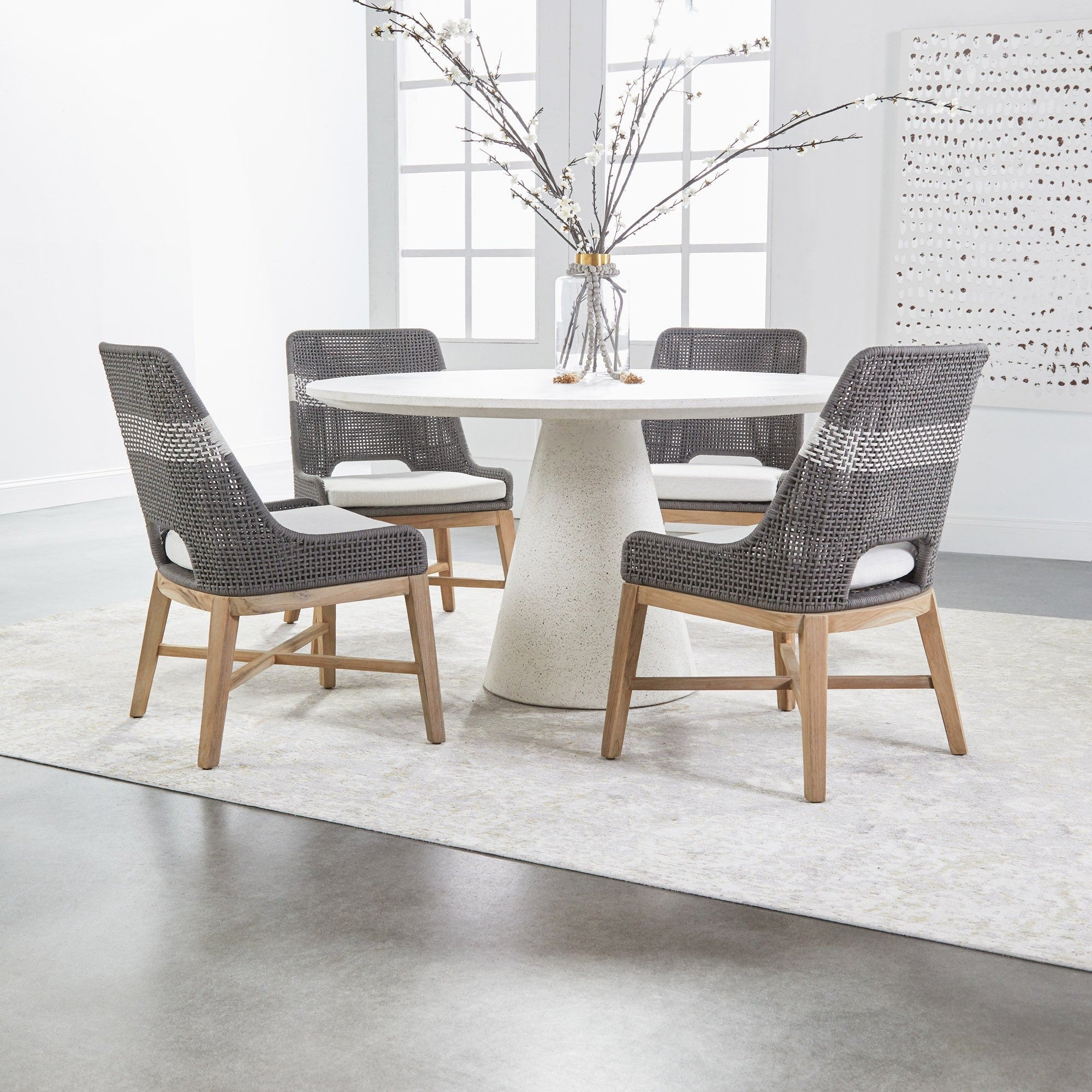 Set of two Essentials for Living tapestry dining chairs with woven taupe backs and mahogany legs around white round table
