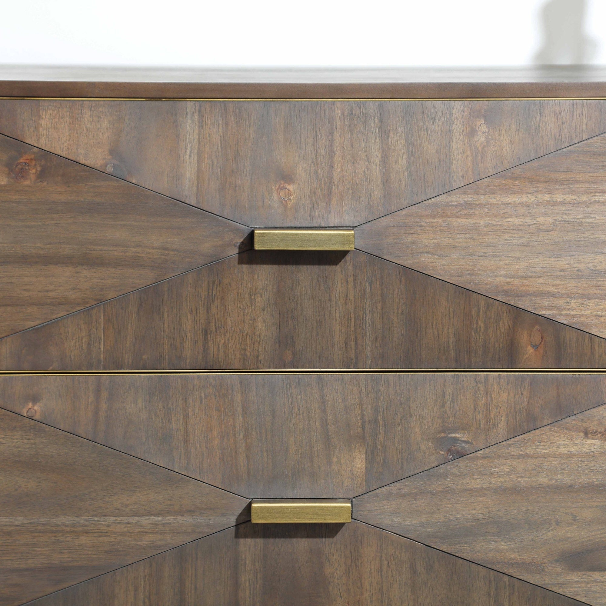 Close-up of Wynn dresser drawer fronts with textured burnished brown acacia wood and brushed gold handles by Essentials For Living