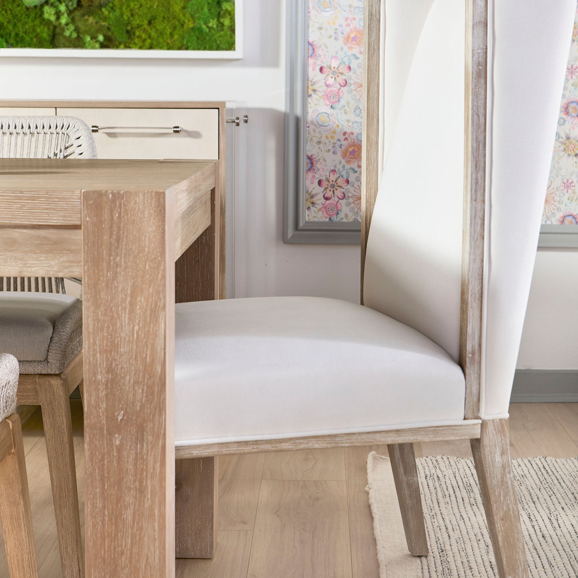 Adler Extension Dining Table in light honey oak with thick legs and white upholstered chair by Essentials for Living