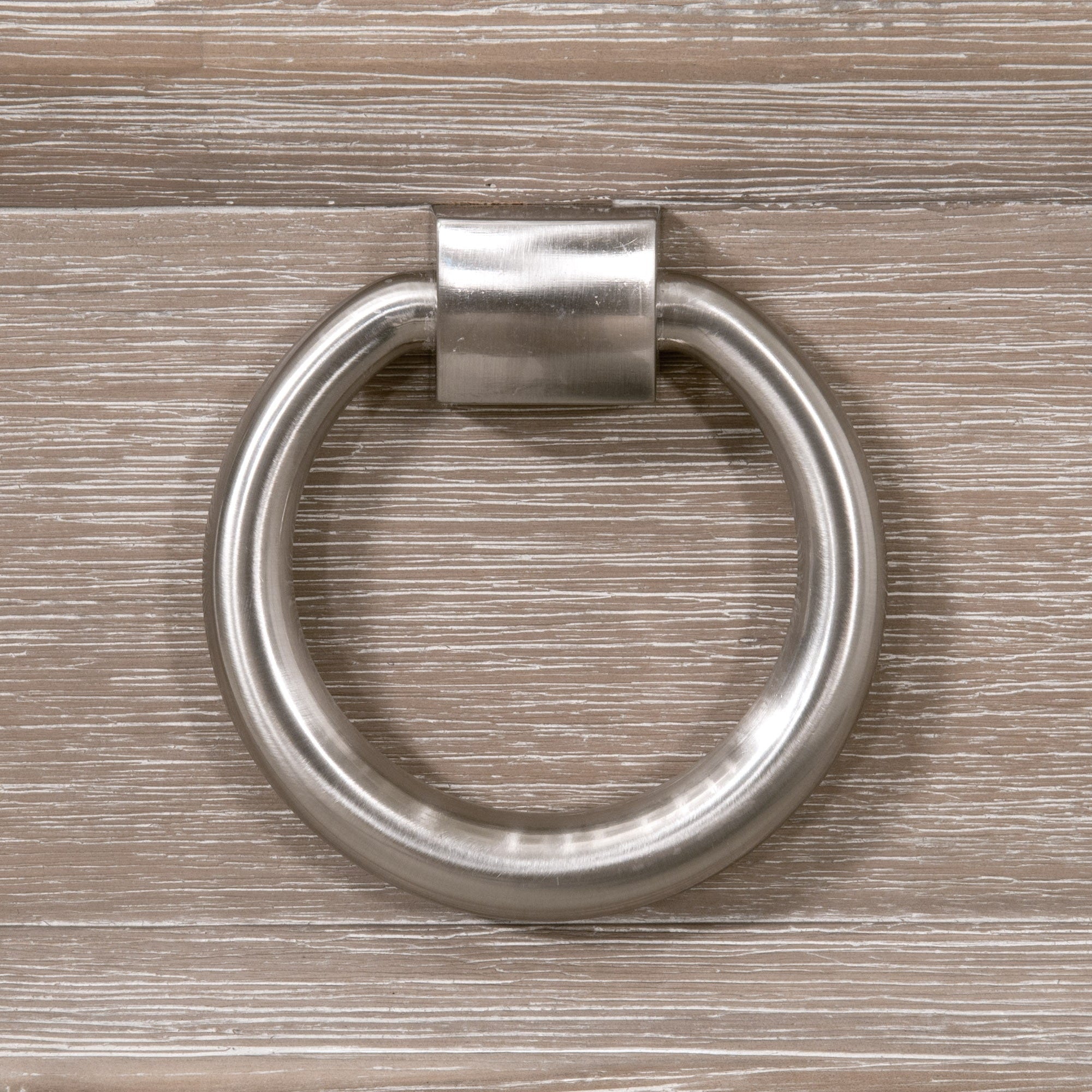 Close-up of brushed steel ring pull on natural gray acacia wood from Azure Carrera 6-Drawer Double Dresser by Essentials for Living