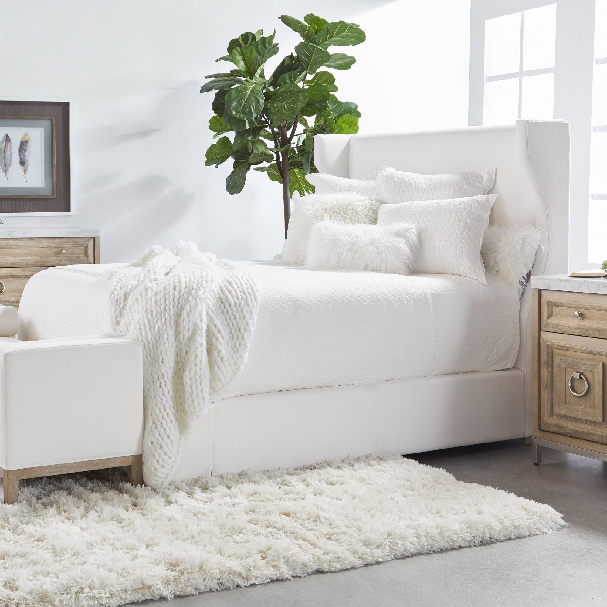 Cozy white bed with plush pillows and throw, natural light, and Essentials for Living Azure Carrera 6-Drawer Double Dresser.
