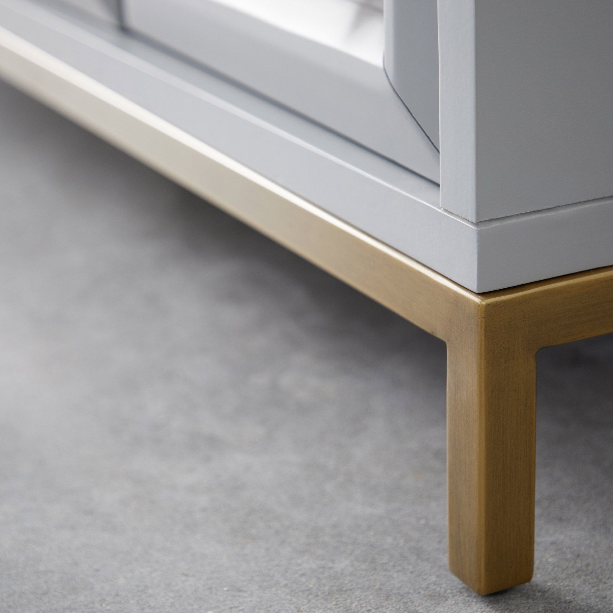 Close-up of brushed gold base on Azure Carrera Media Sideboard with navy lacquer finish by Essentials for Living