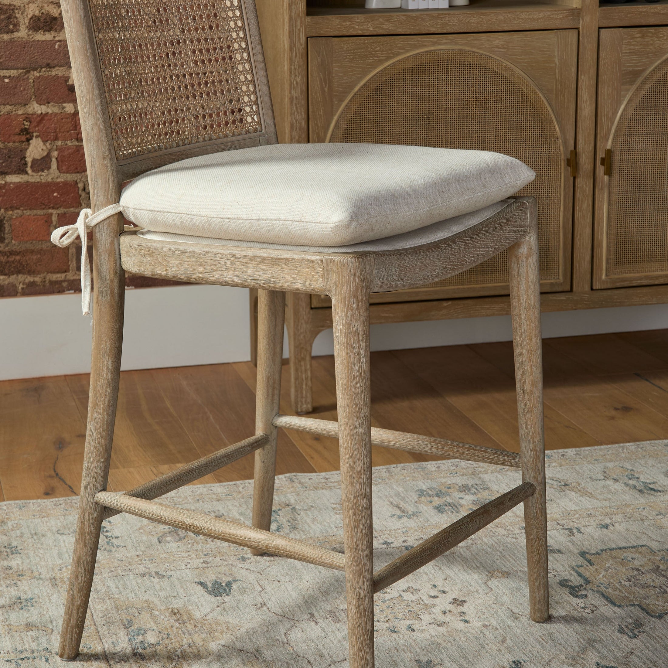 Blume Counter Stool with cream linen cushion, natural gray oak frame, and cane back by Your Noble Nest
