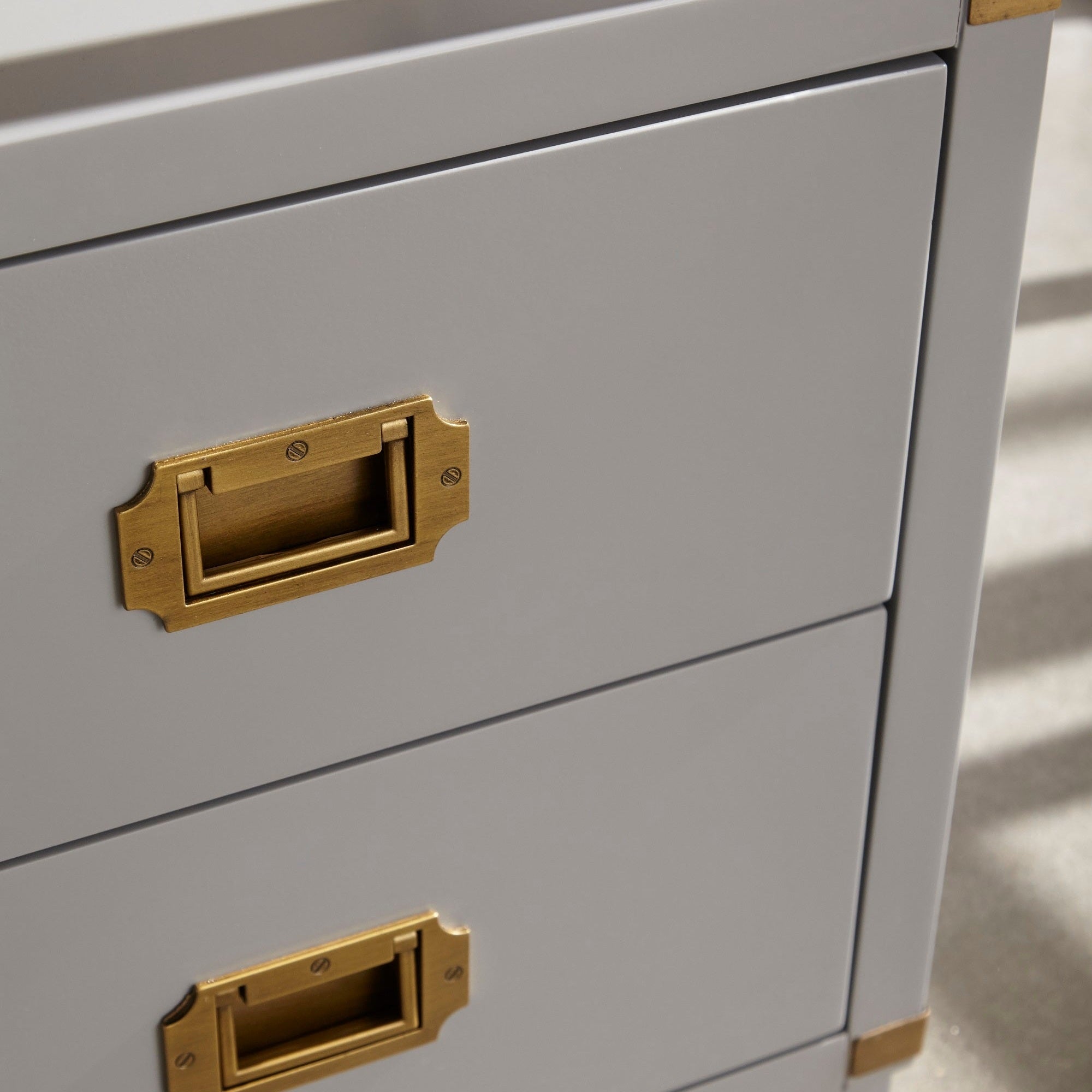 Close-up of brushed gold hardware on Bradley 2-Drawer Nightstand in gray finish by Essentials for Living