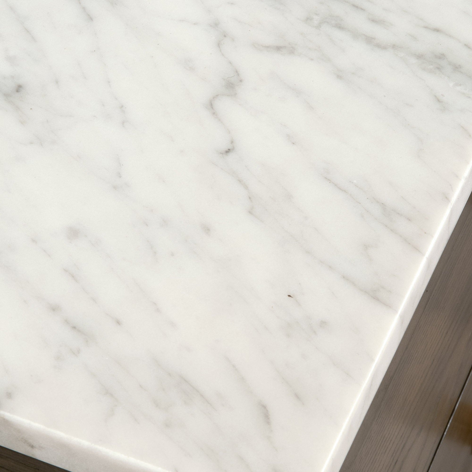 Close-up of Bianco marble top on Cambria 8-Drawer Double Dresser by Essentials For Living