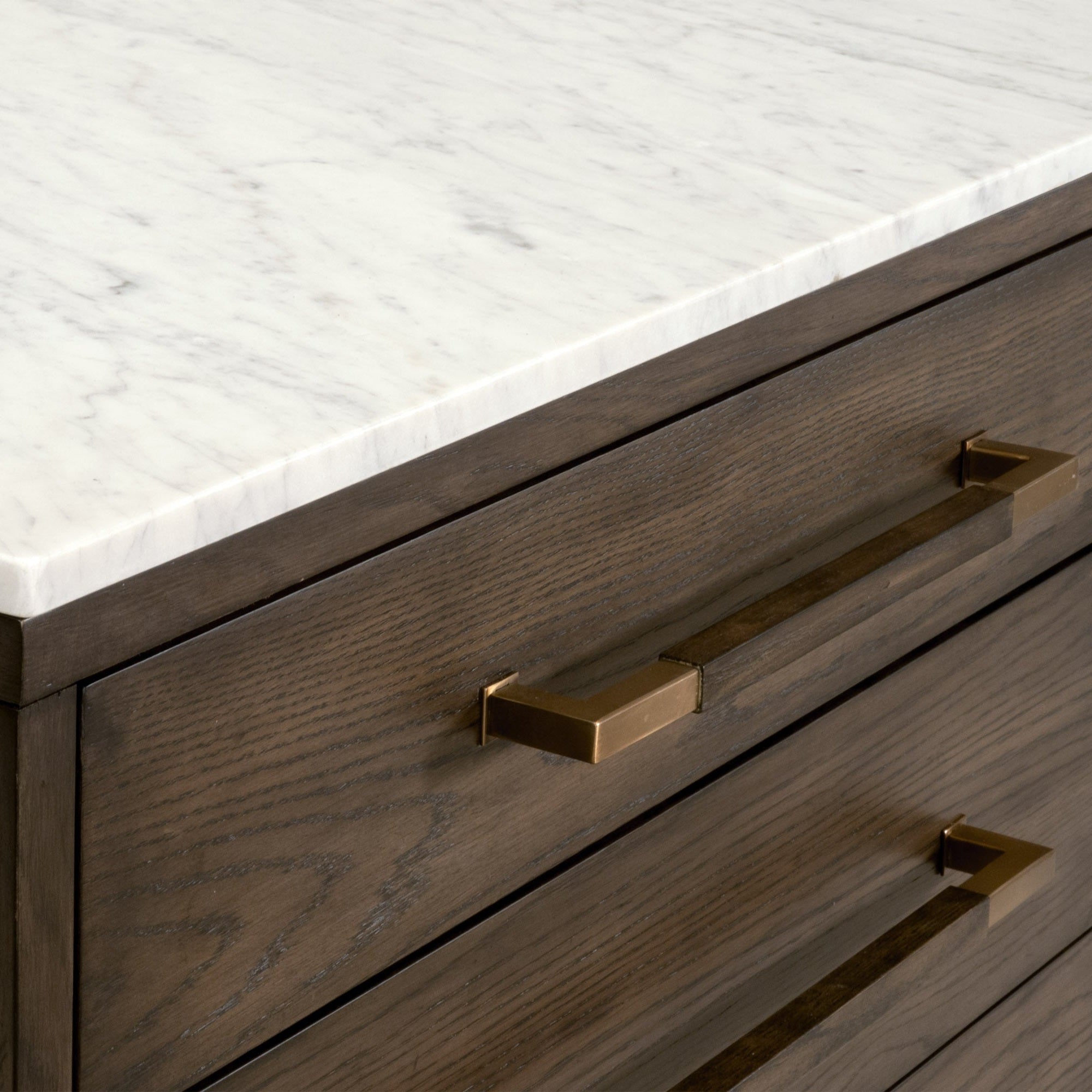 Close-up of Cambria 8-Drawer Double Dresser with Bianco marble top and aged brass pulls by Essentials for Living