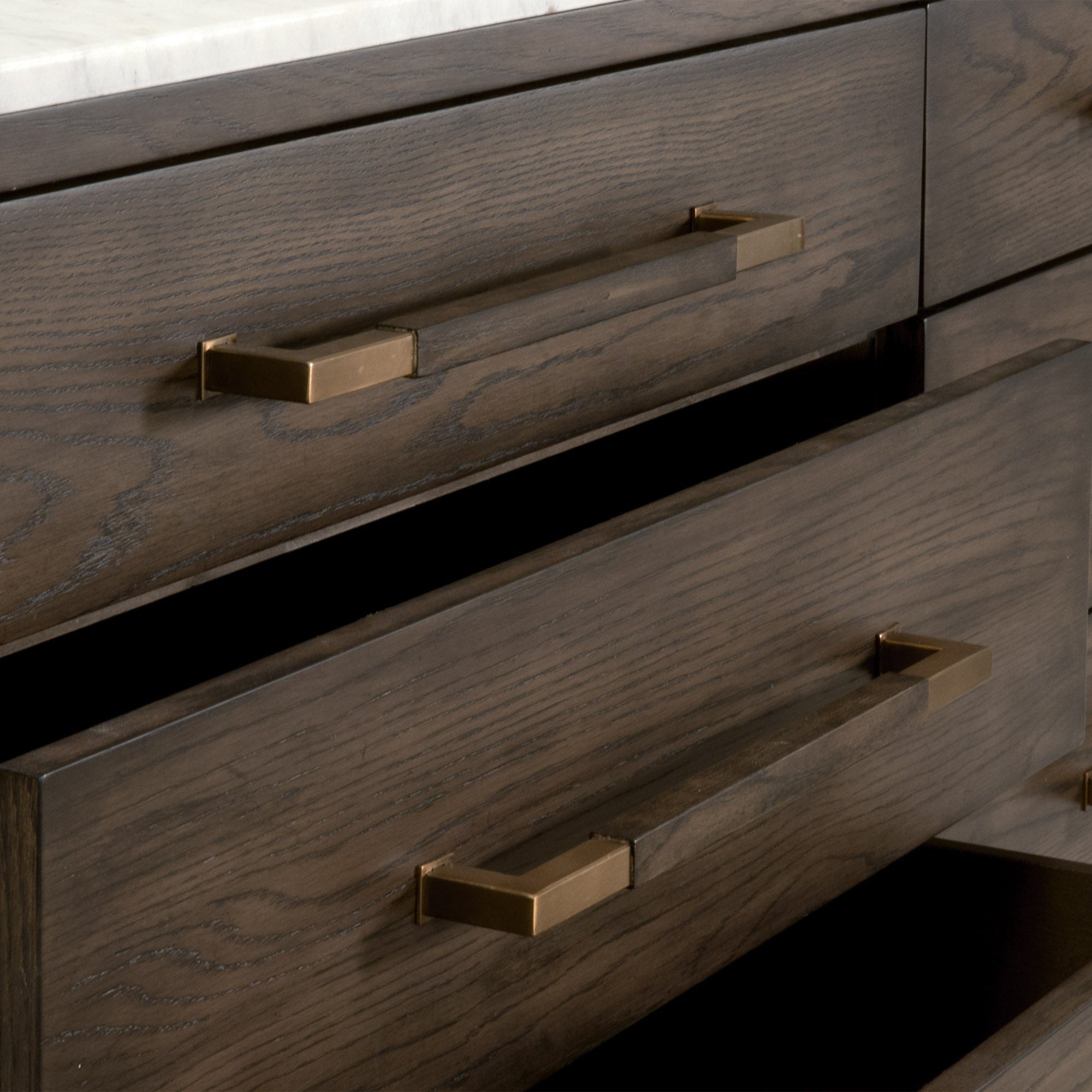 Close-up of aged brass drawer pulls on the Cambria 8-Drawer Double Dresser by Essentials for Living