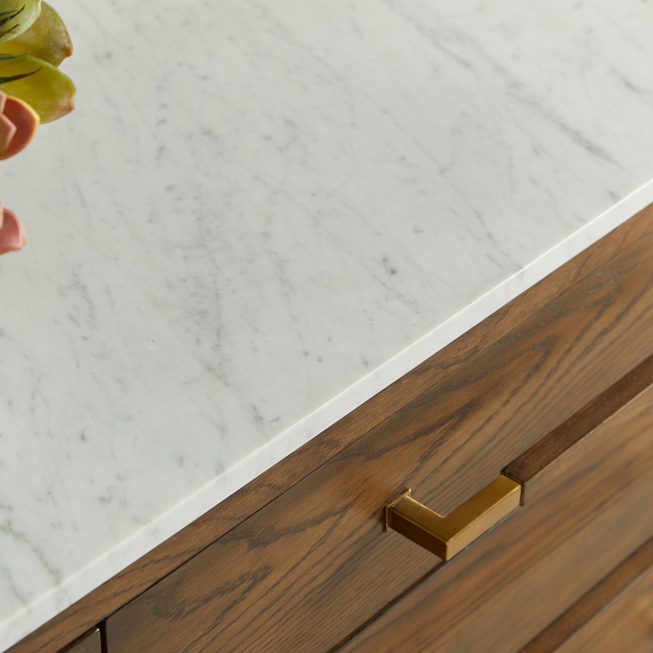 Close-up of Cambria 8-Drawer Double Dresser with Bianco marble top and aged brass pulls by Essentials for Living