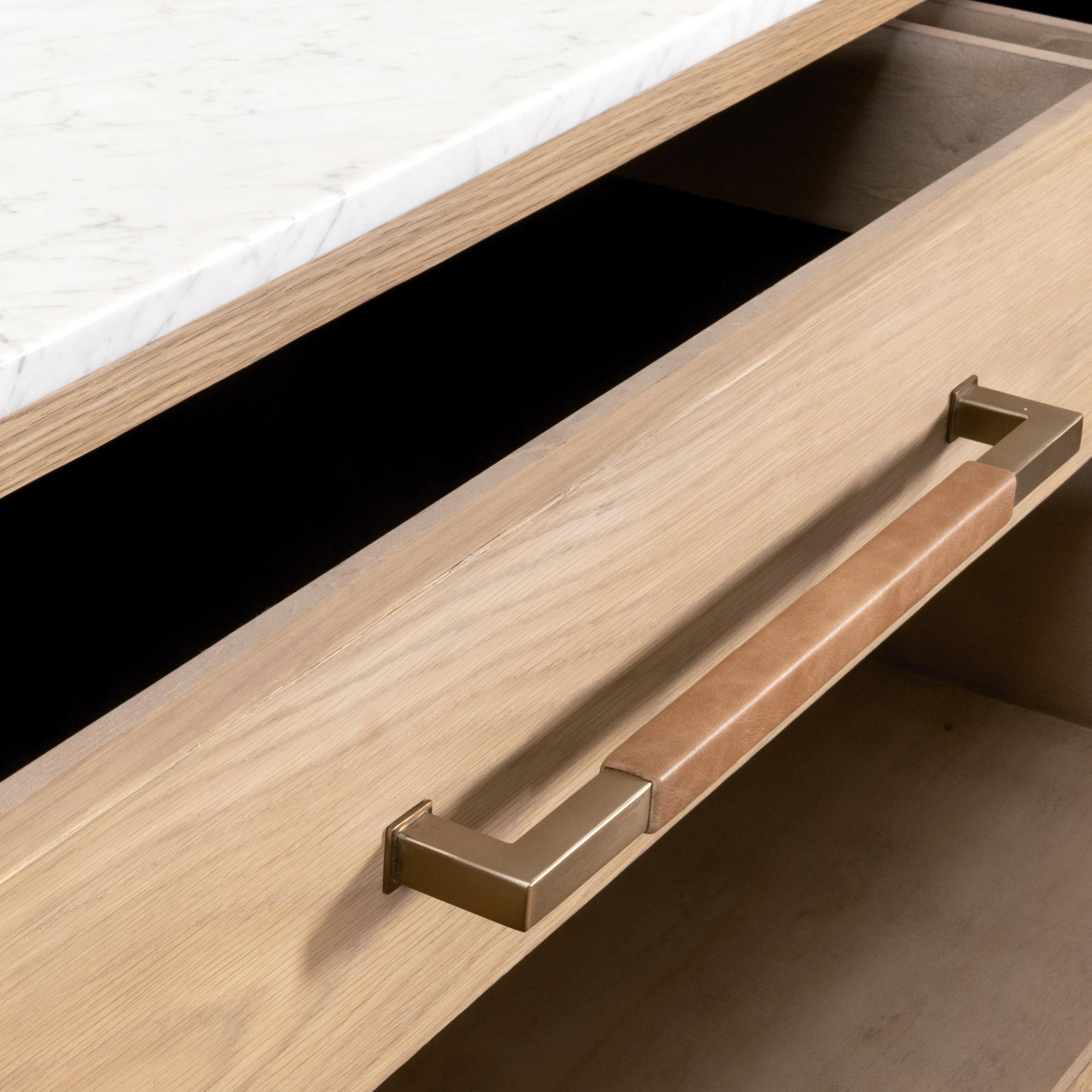 Close-up of Cambria 8-Drawer Double Dresser drawer with marble top and aged brass handle by Essentials for Living