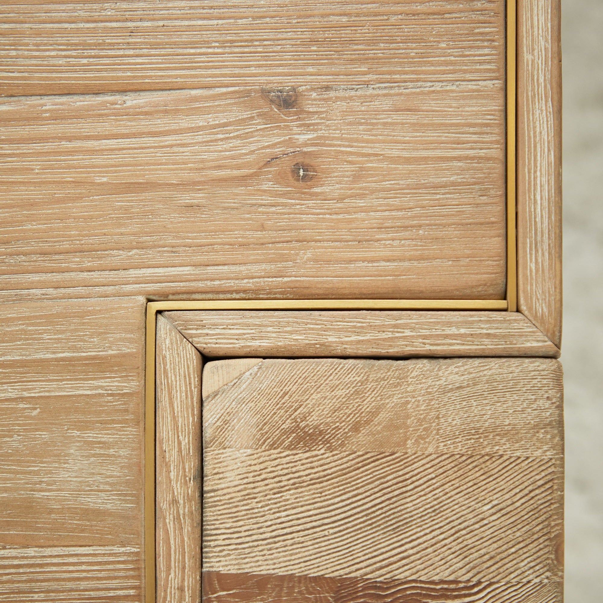 Close-up of smoke gray reclaimed pine wood grain and brushed gold stainless steel inlay on Canal Extension Dining Table corner.