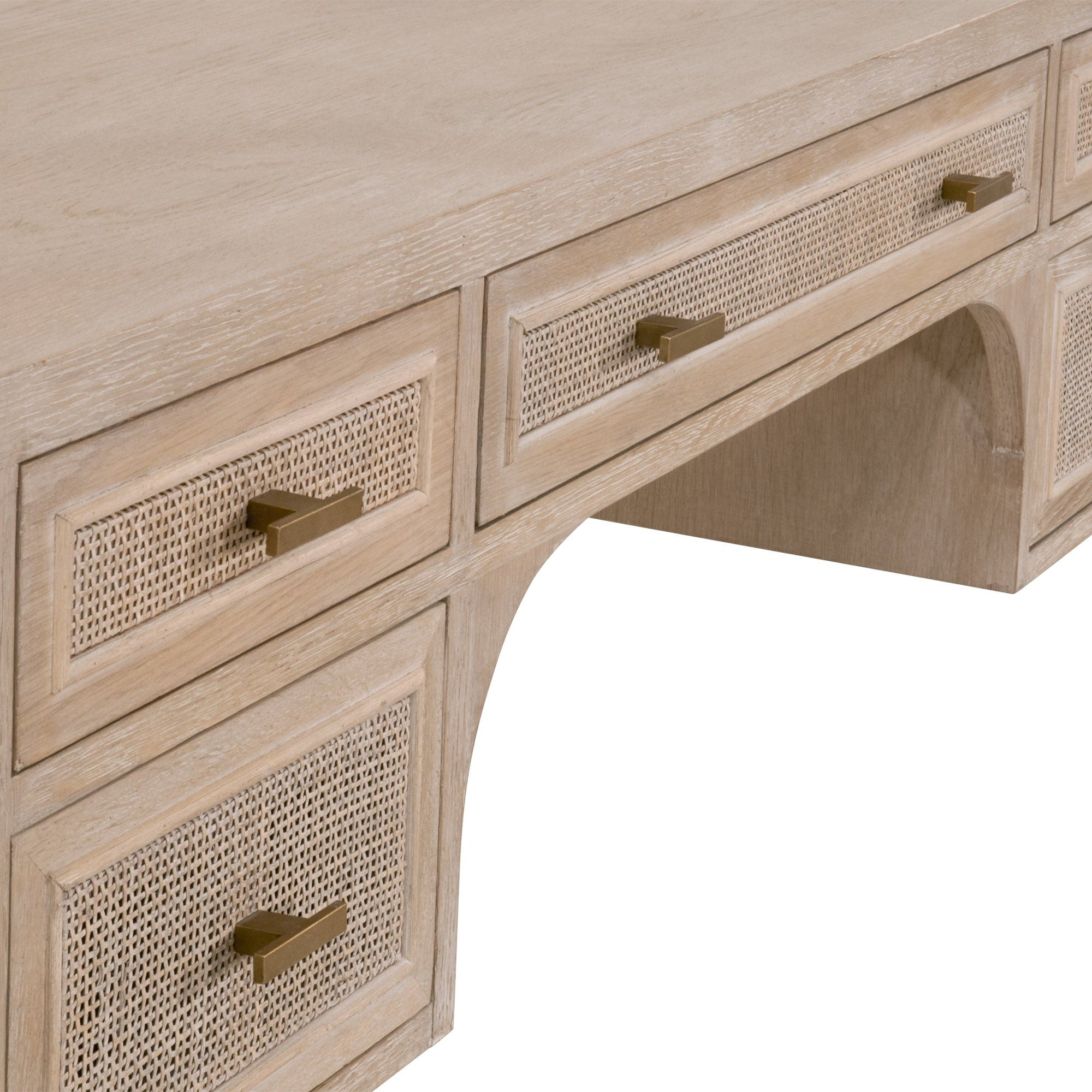 Close-up of Cane Desk drawer fronts with natural cane inlay and brass handles in smoke gray oak finish
