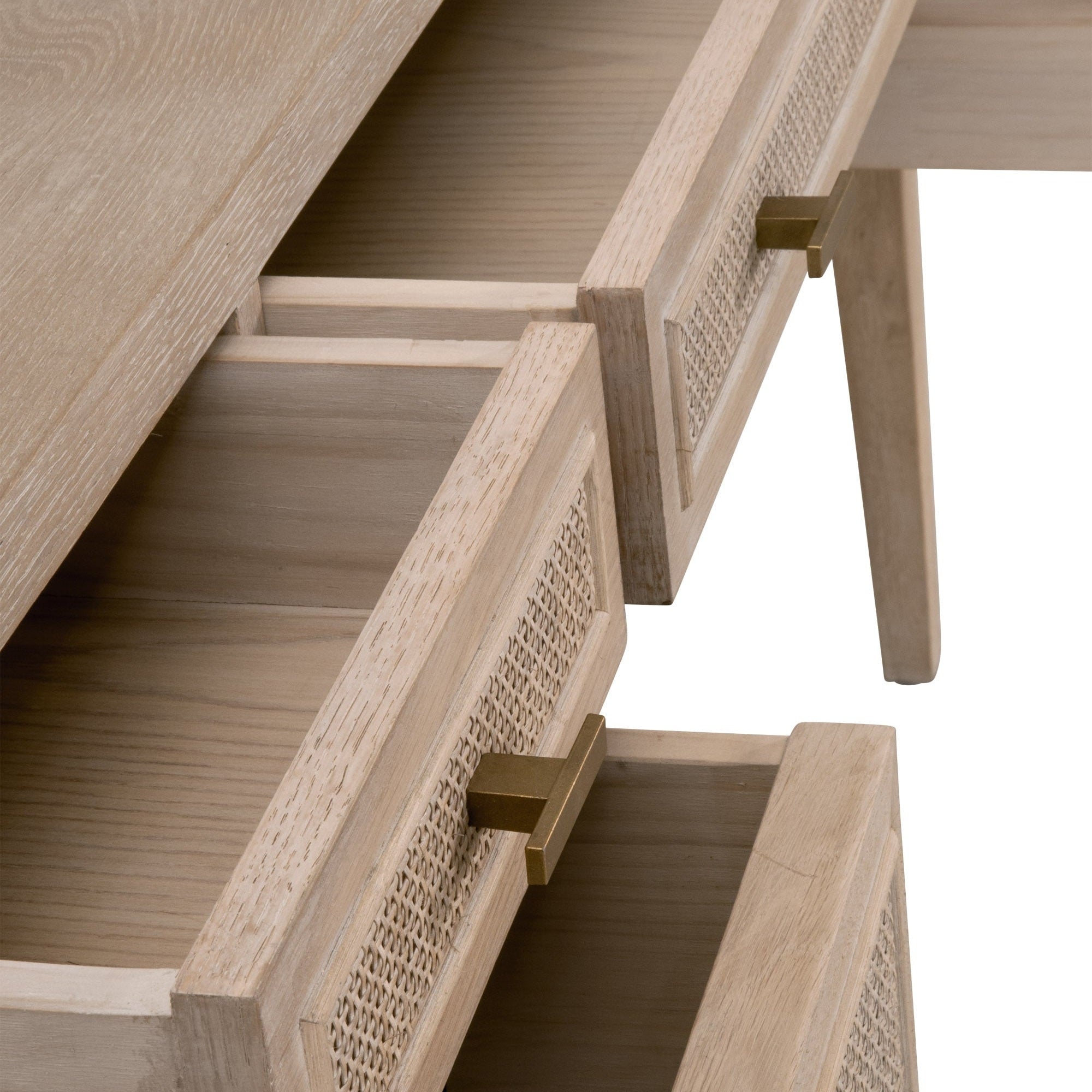 Close-up of Essentials for Living Cane Desk drawers featuring smoke gray oak with cane inlay and brass handles