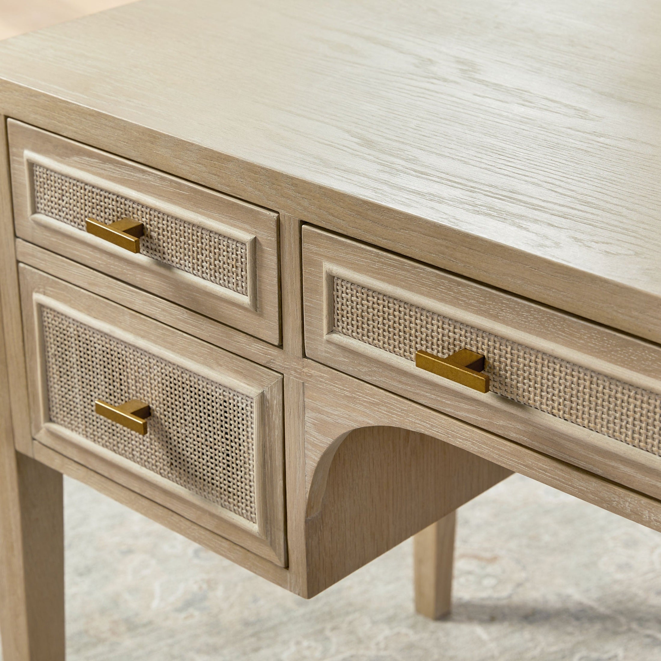 Close-up of a solid oak cane desk drawer with gold handles in a smoke gray finish by Essentials For Living