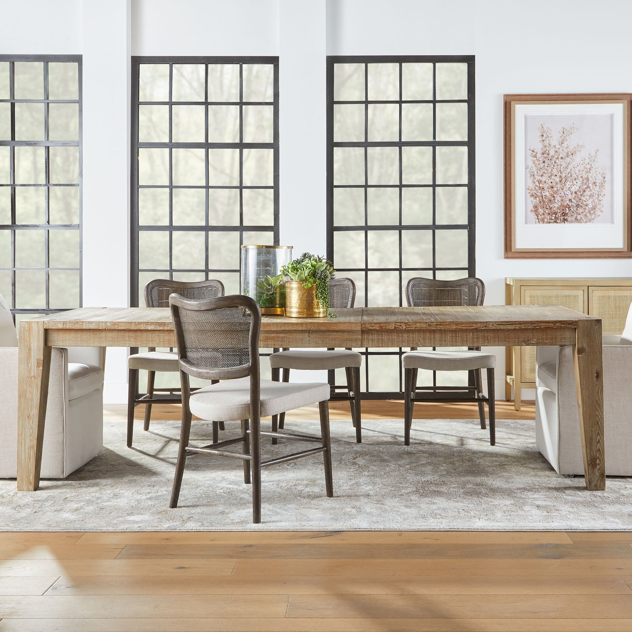 Set of two Cela Dining Chairs by Essentials for Living with oak frame, handwoven cane back, and bisque upholstered seat