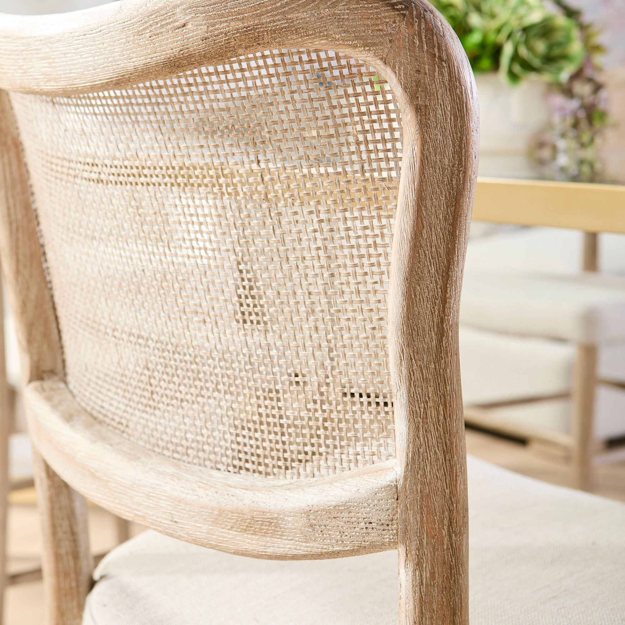 Close-up of Cela Dining Chair’s handwoven cane backrest and natural gray oak frame by Essentials for Living