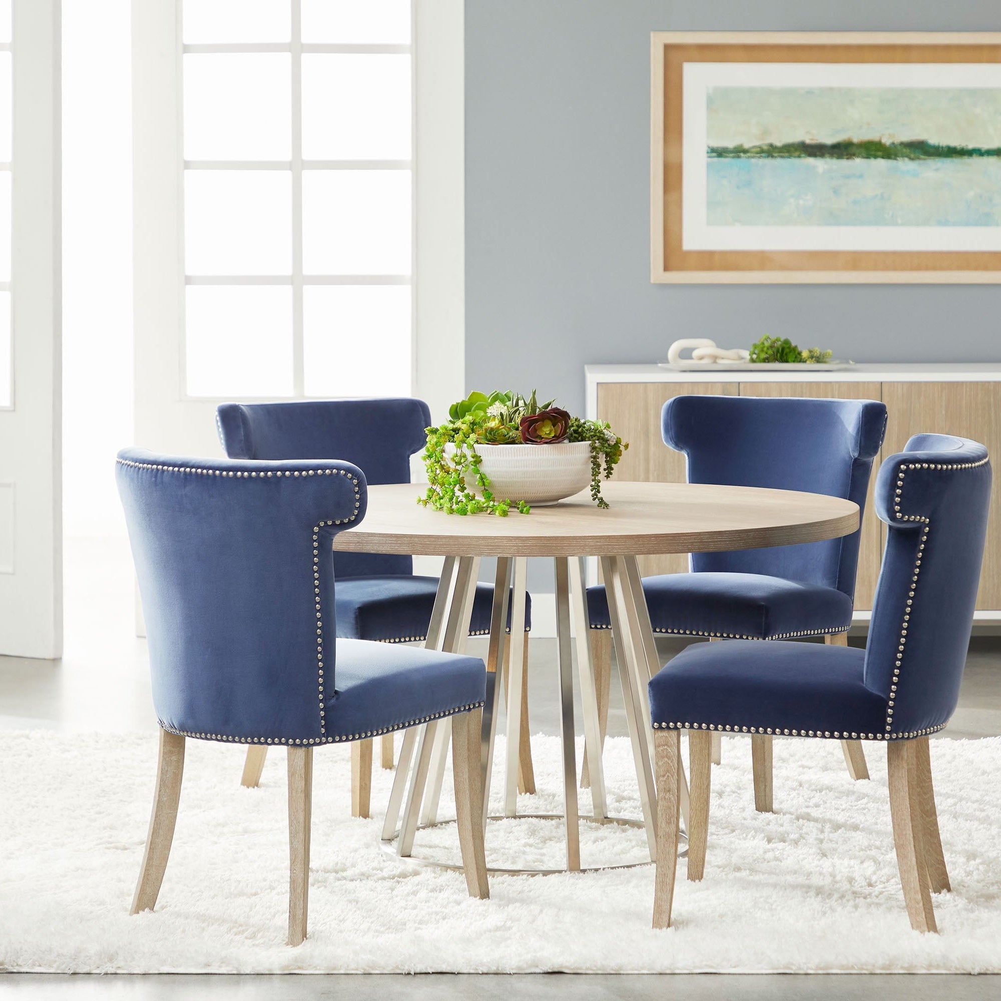 Essentials for Living Celina Dining Chair in denim velvet with natural gray oak legs around a round wood table