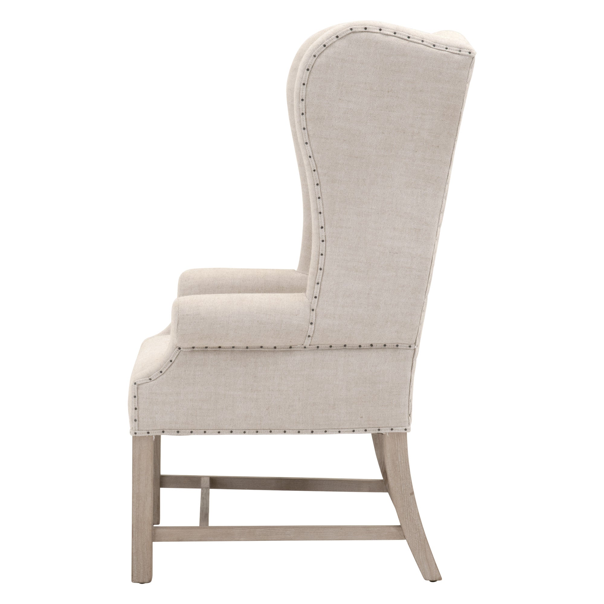 Side view of Essentials For Living Chateau Arm Chair in bisque linen with nailhead trim and natural gray wood frame