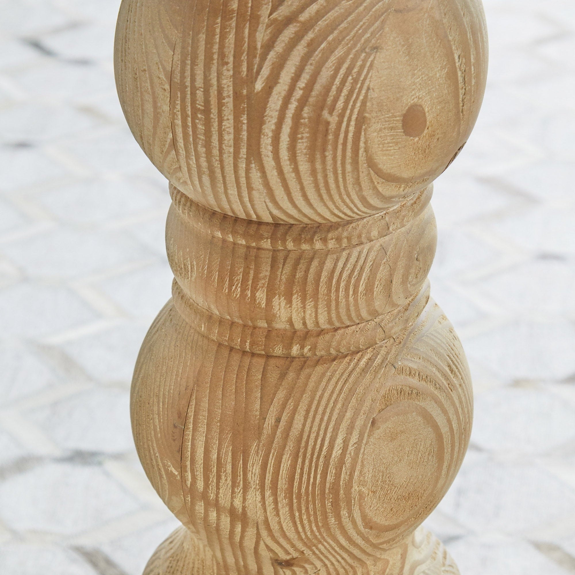 Close-up of turned pedestal base made from reclaimed white pine wood on Chelsea 36 inch round dining table