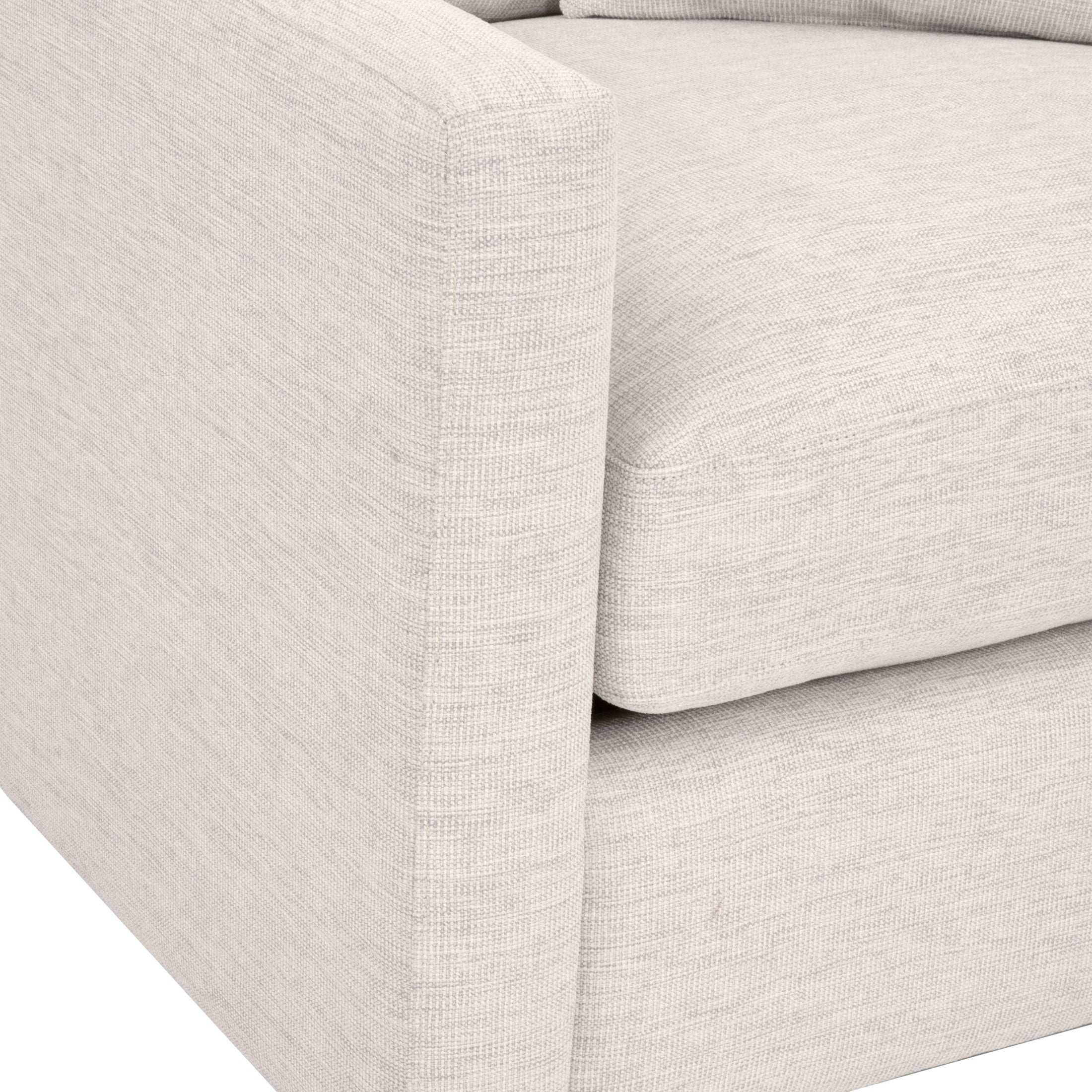 Close-up of light gray basketweave fabric upholstery and cushioned armrest on Essentials for Living Clara Sofa Chair
