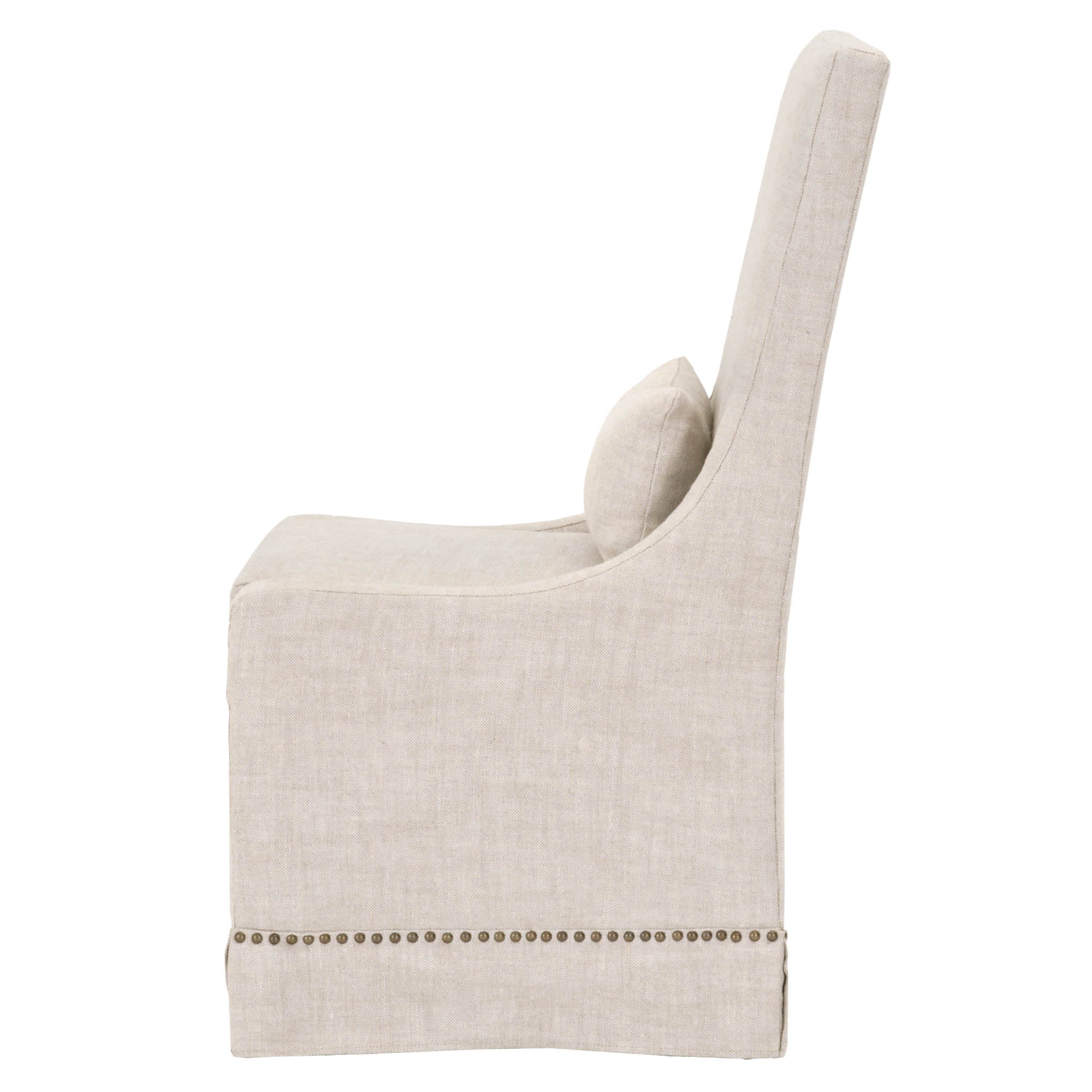 Side view of Essentials For Living Colleen Dining Chair in creamy bisque linen with gold nailhead trim and lumbar pillow
