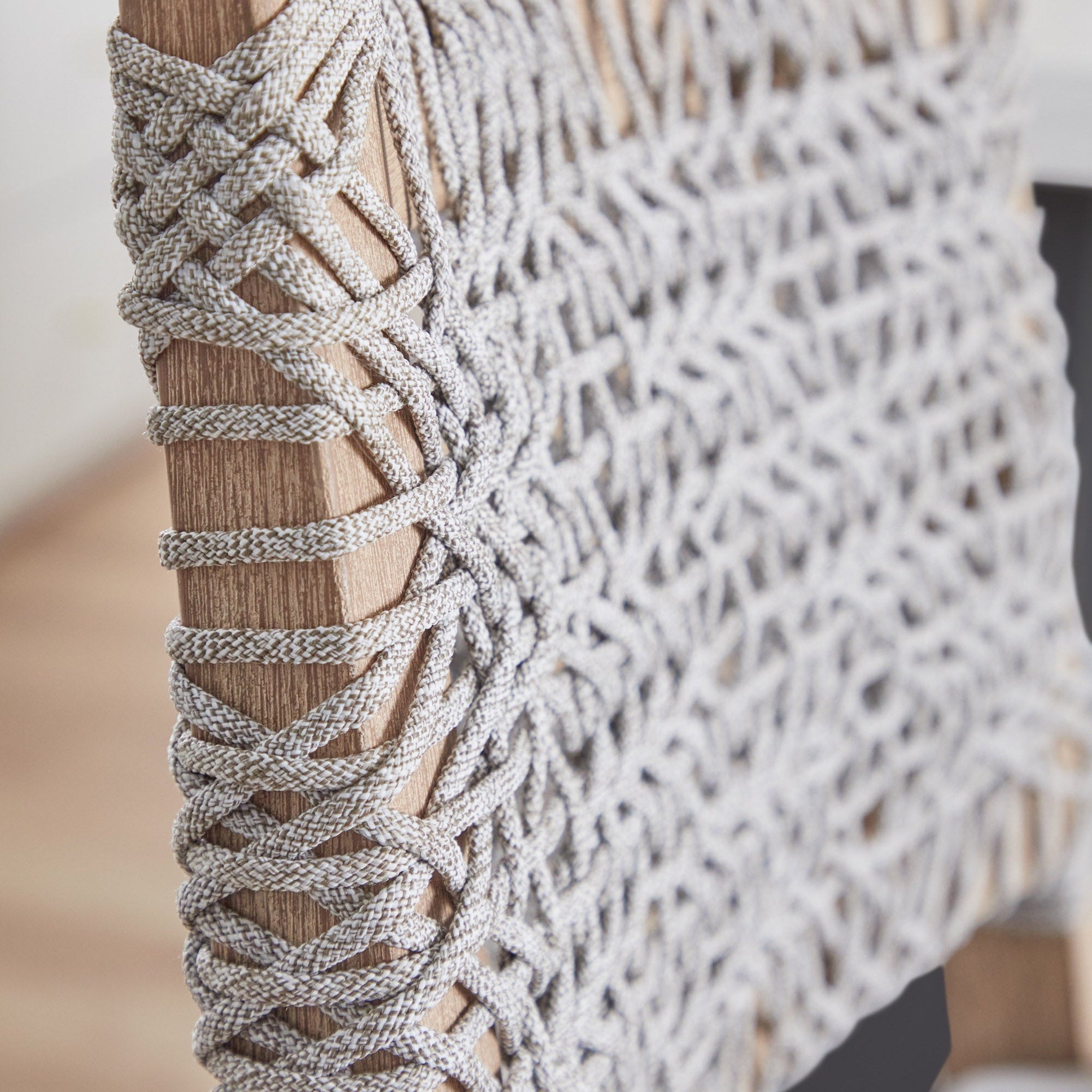Close-up of white and taupe woven polypropylene rope detail on Coastal Essentials for Living counter stool frame
