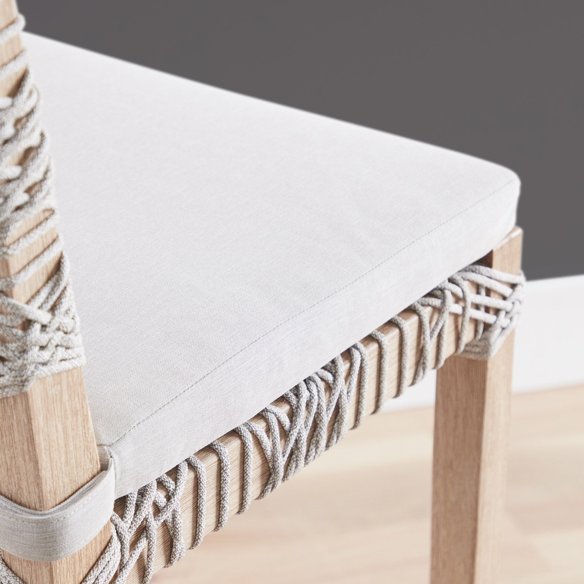 Close-up of Essentials For Living Costa Counter Stool showing white cushion and taupe woven polypropylene seat with natural wood frame