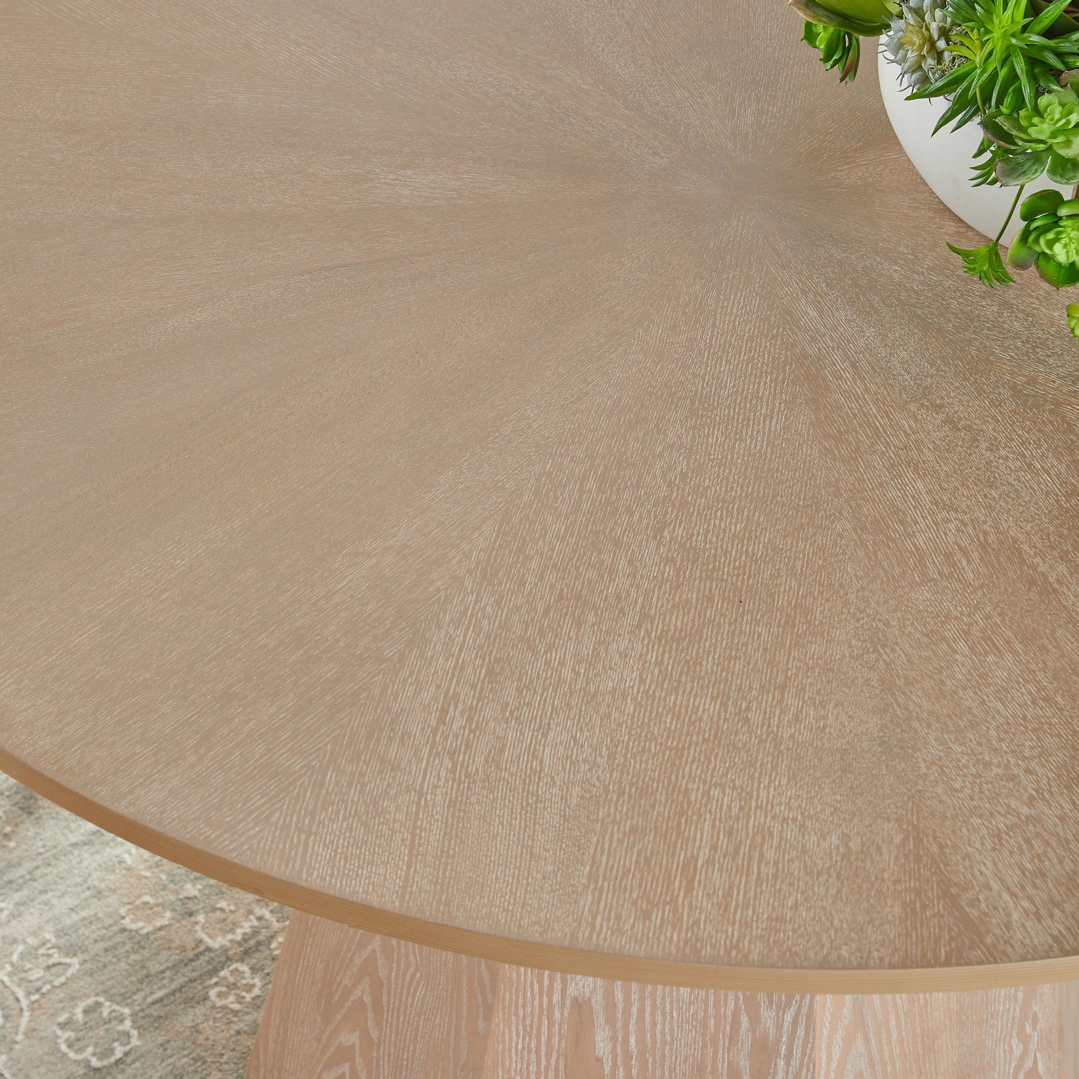 Close-up of Essentials for Living Coulter 42-inch round dining table with natural gray ash wood starburst tabletop pattern